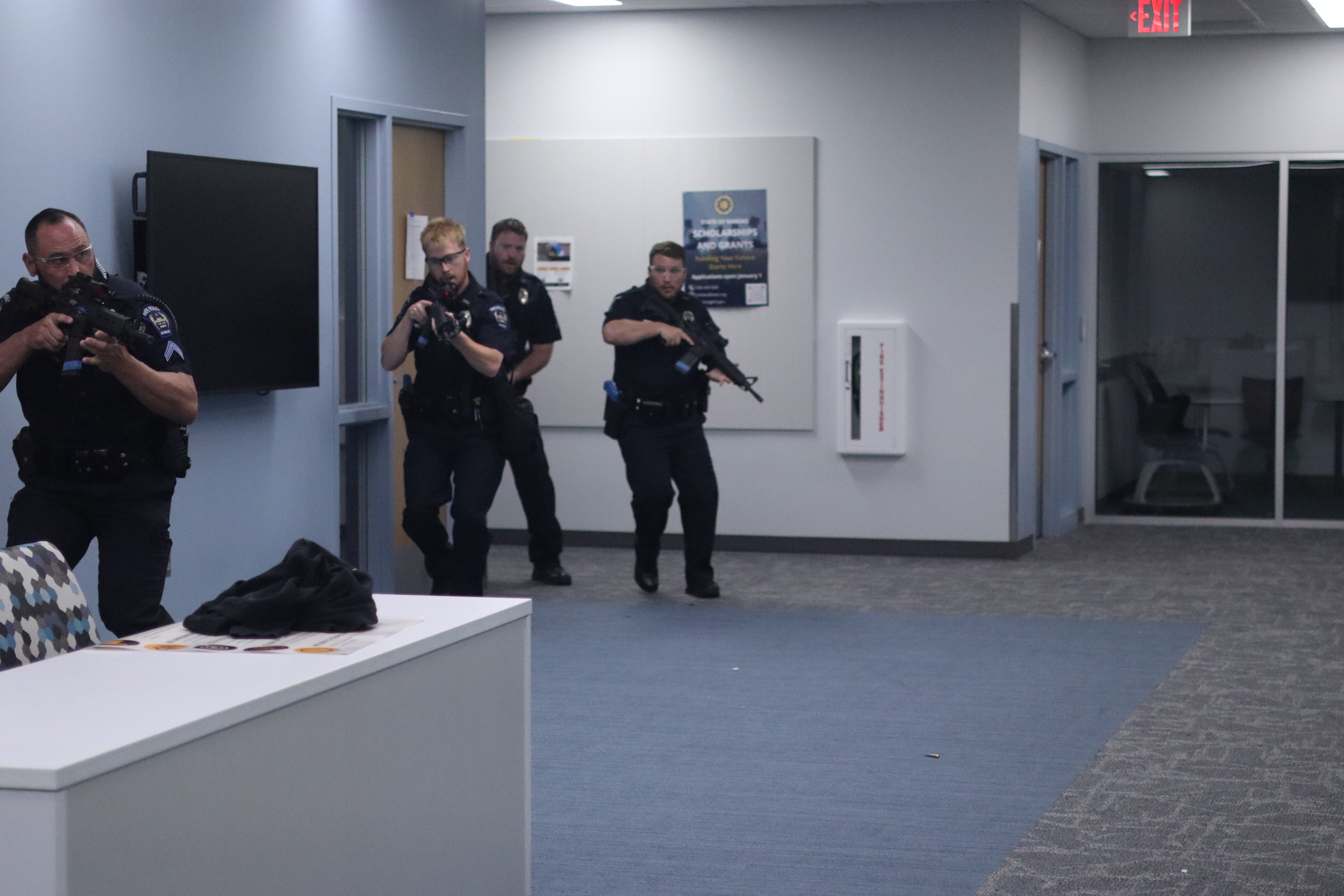 Hays Police Department officers clear a room during an active shooter training exercise at Hays High School.<br>