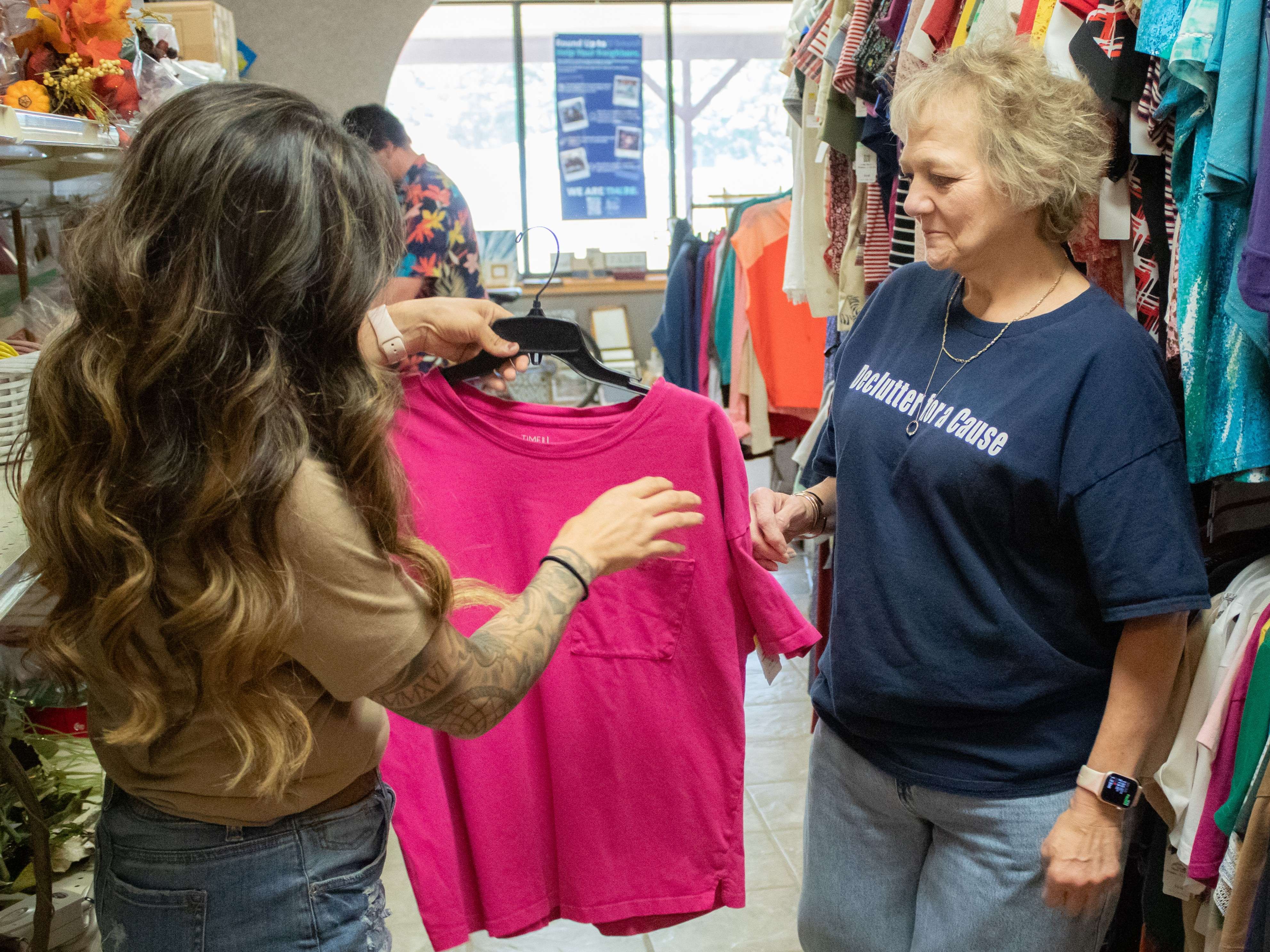 A Golden Harvest Thrift Store team member helps a customer browse clothing at the Great Bend store. The thrift store will celebrate its first anniversary on Saturday, Aug. 1, marking a year of providing affordable shopping opportunities while supporting the mission of Catholic Charities Southwest Kansas.