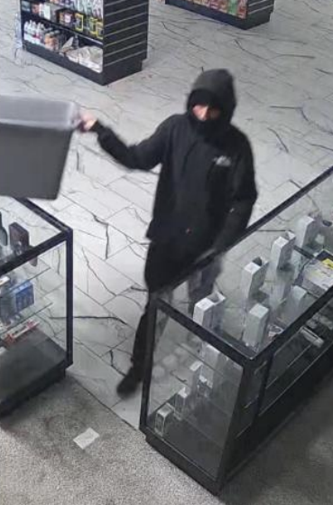 Surveillance footage shows an unknown suspect stealing several items from a Salina smoke shop - SPD photo