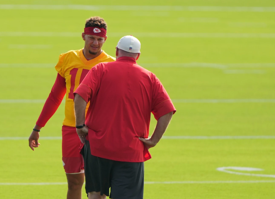 Kansas City Chiefs quarterback Patrick Mahomes talks with head coach Andy Reid at NFL football training camp Saturday, July 25, 2026, in St. Joseph, Mo. (AP Photo/Charlie Riedel)