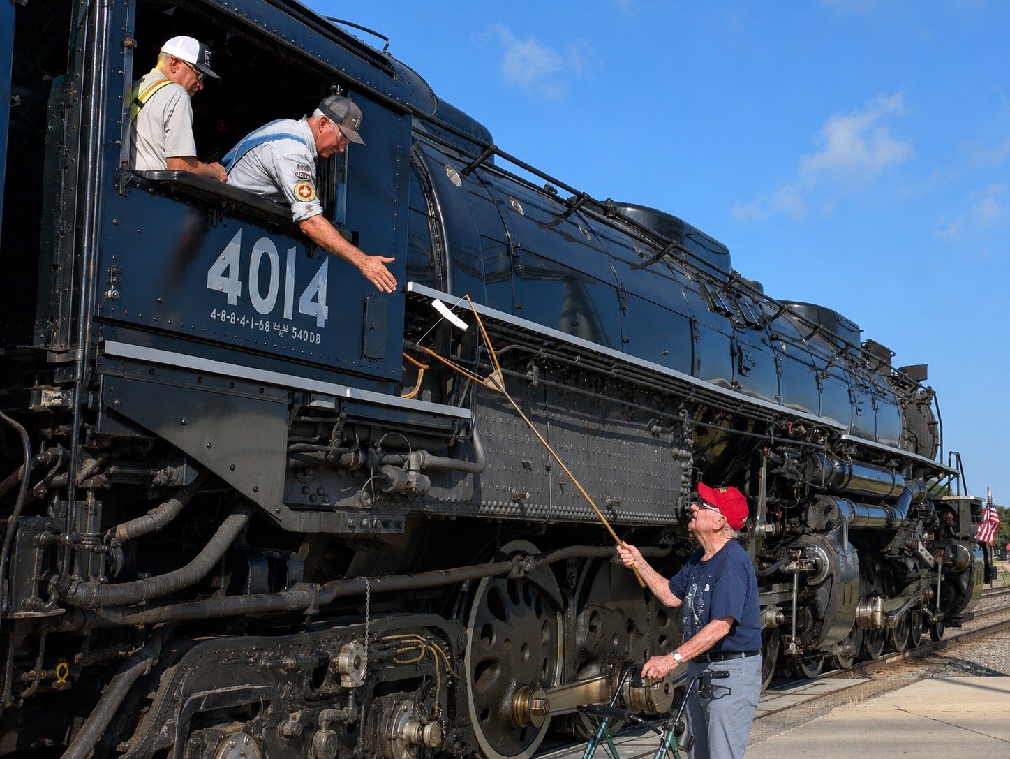 Jim Stramel, right, is using a Y-Stick to give signs to "Big Boy" No. 4014 engineer Ed Dickens, middle. Photo courtesy of &nbsp;Dr. Janet Stramel