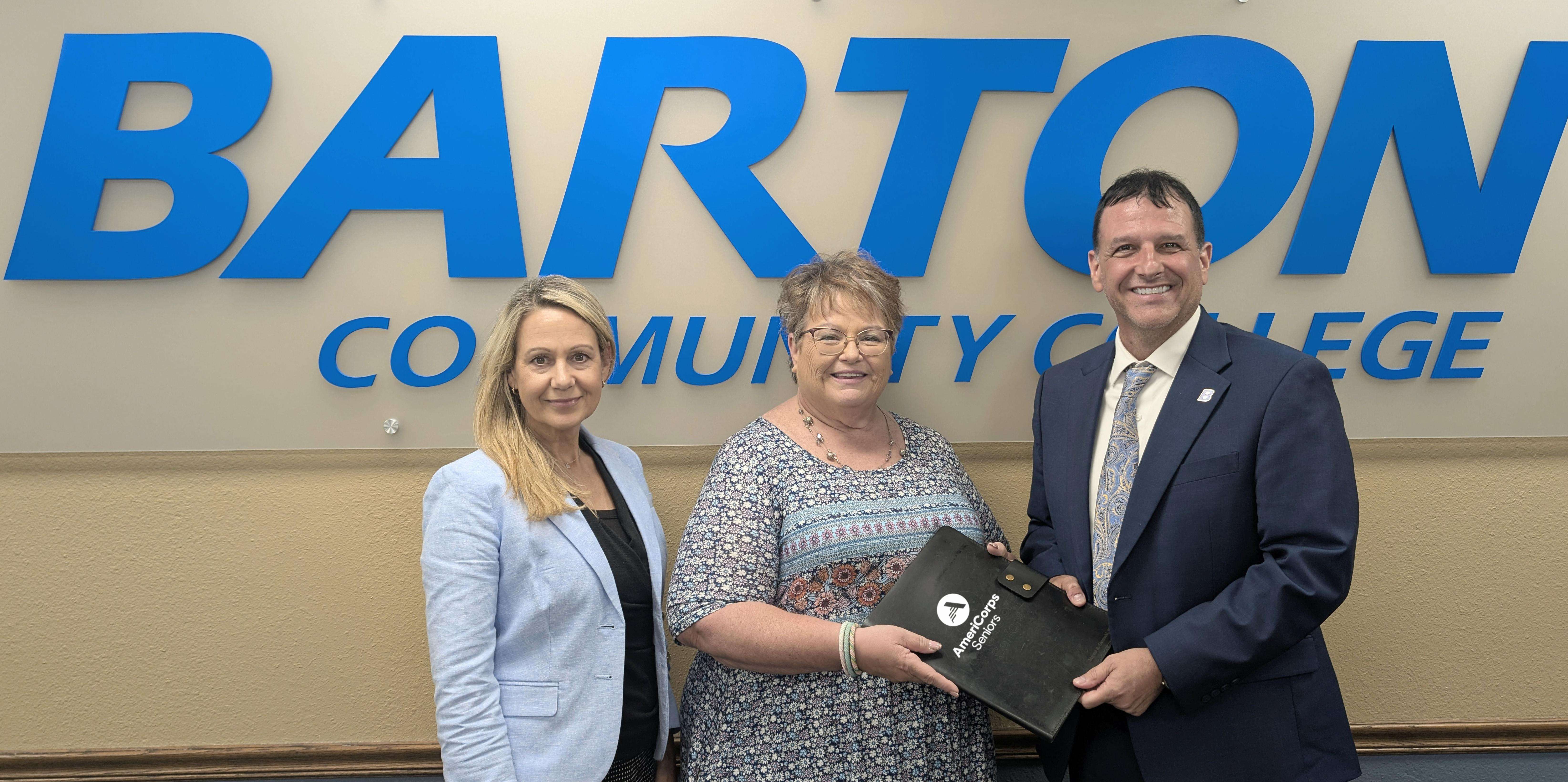 Barton President Dr. Marcus Garstecki (right) announces the acceptance of the 2026 AmeriCorps Seniors RSVP Grant alongside Volunteers In Action Director Linn Hogg (center) and Barton Vice President of Student Services and AmeriCorps Seniors RSVP Sponsor Angie Maddy earlier this summer.