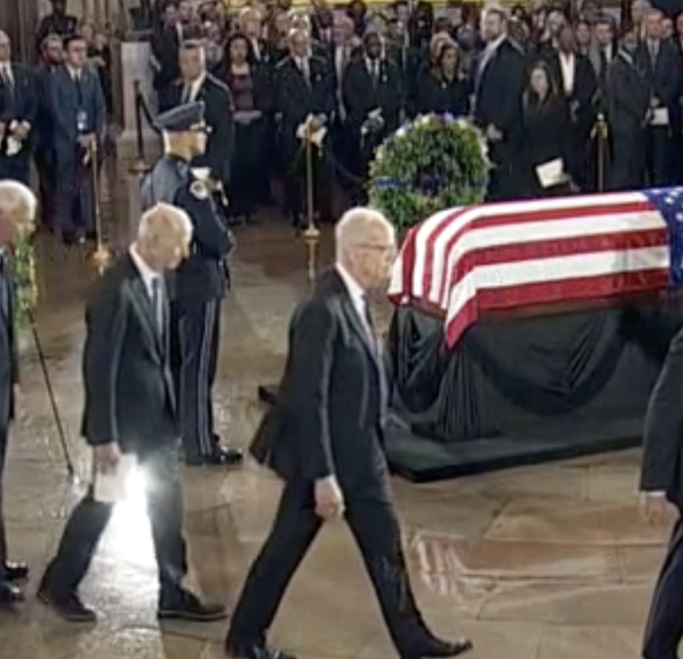 Kansas U.S. Senator Jerry Moran walks by Graham's flag draped coffin during the memorial service in the U.S. Capitol- photo from CSPAN video