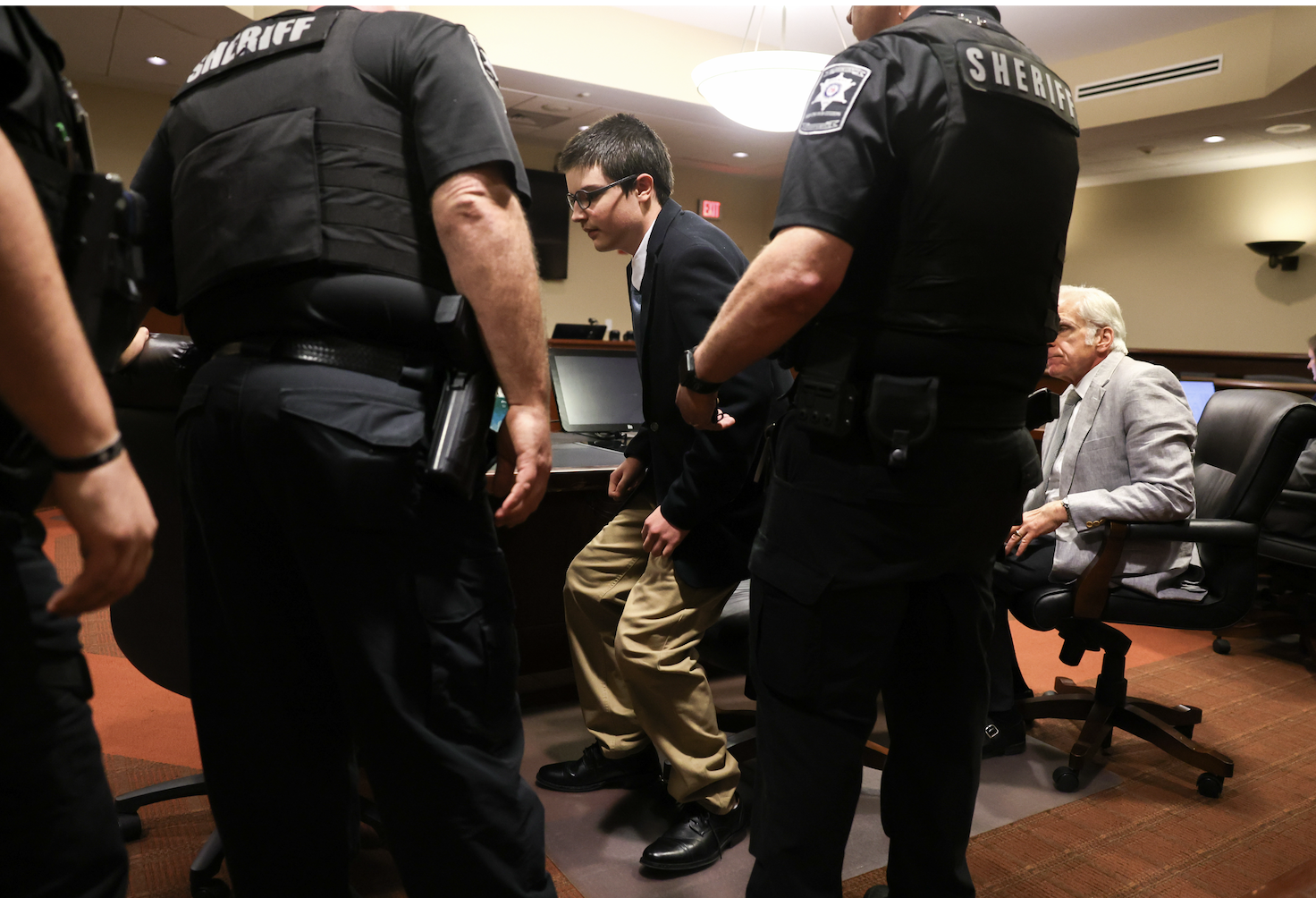 Colt Gray, the 16-year-old convicted in the Apalachee High School shooting, stands to be handcuffed following his sentencing at Barrow County Superior Court in Winder, Ga., on Tuesday, July 28, 2026. (Arvin Temkar/Atlanta Journal-Constitution via AP)
