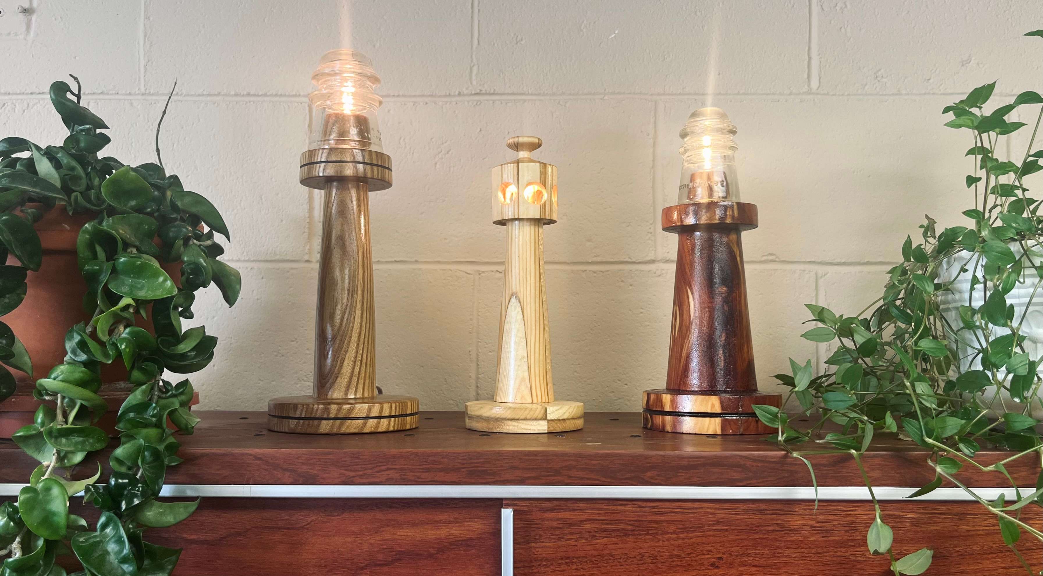 Hand-carved lighthouse prizes are displayed during the 2026 RSVP Raffle. Jan Earley, Ashlee Beckmann and Donna Obermier were the winners of the handcrafted prizes. (Courtesy Photo)