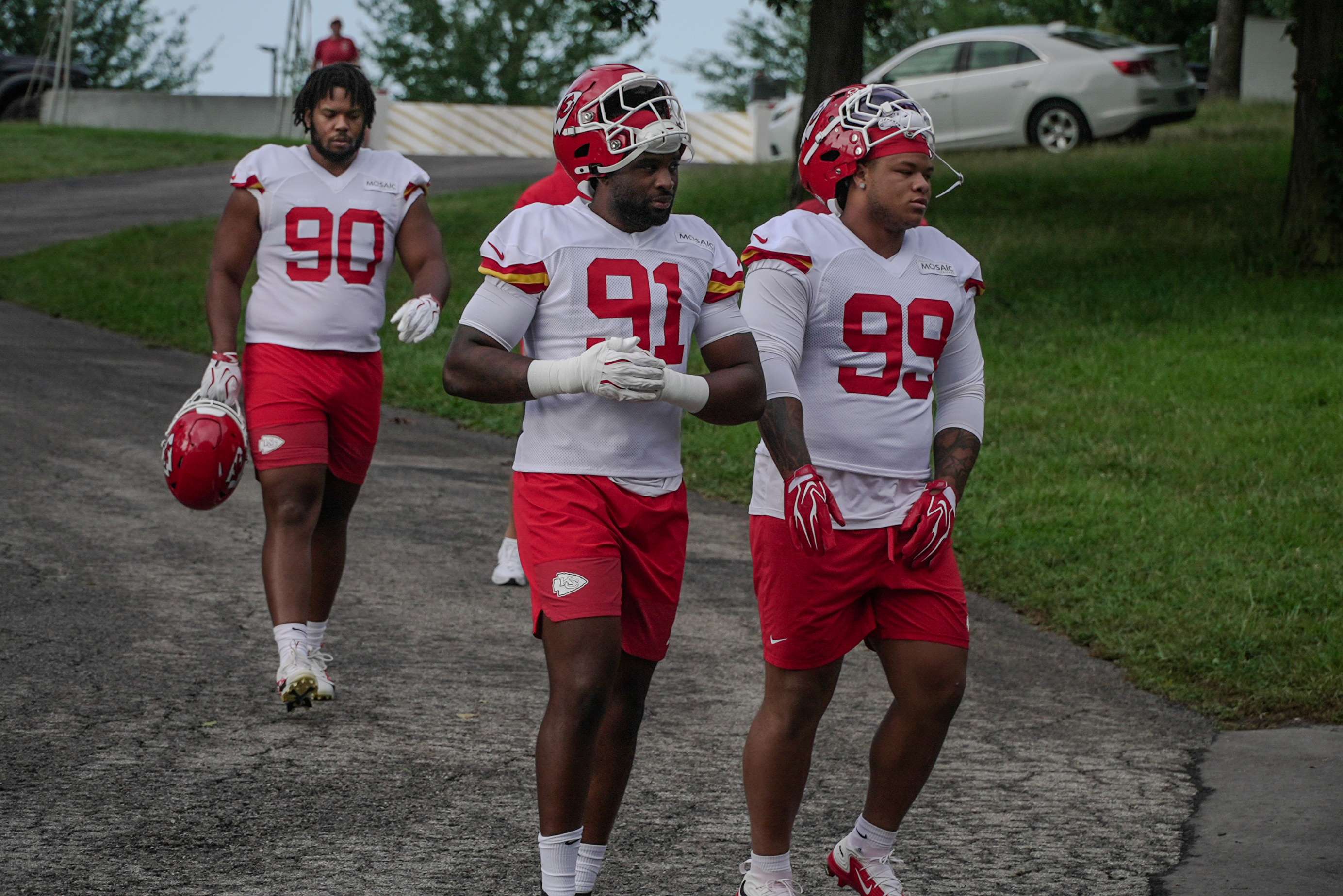 Felix Anudike-Uzomah (91) and Peter Woods (99) walk down the hill to Chiefs Training Camp practice/ Photo by Justin Peacock