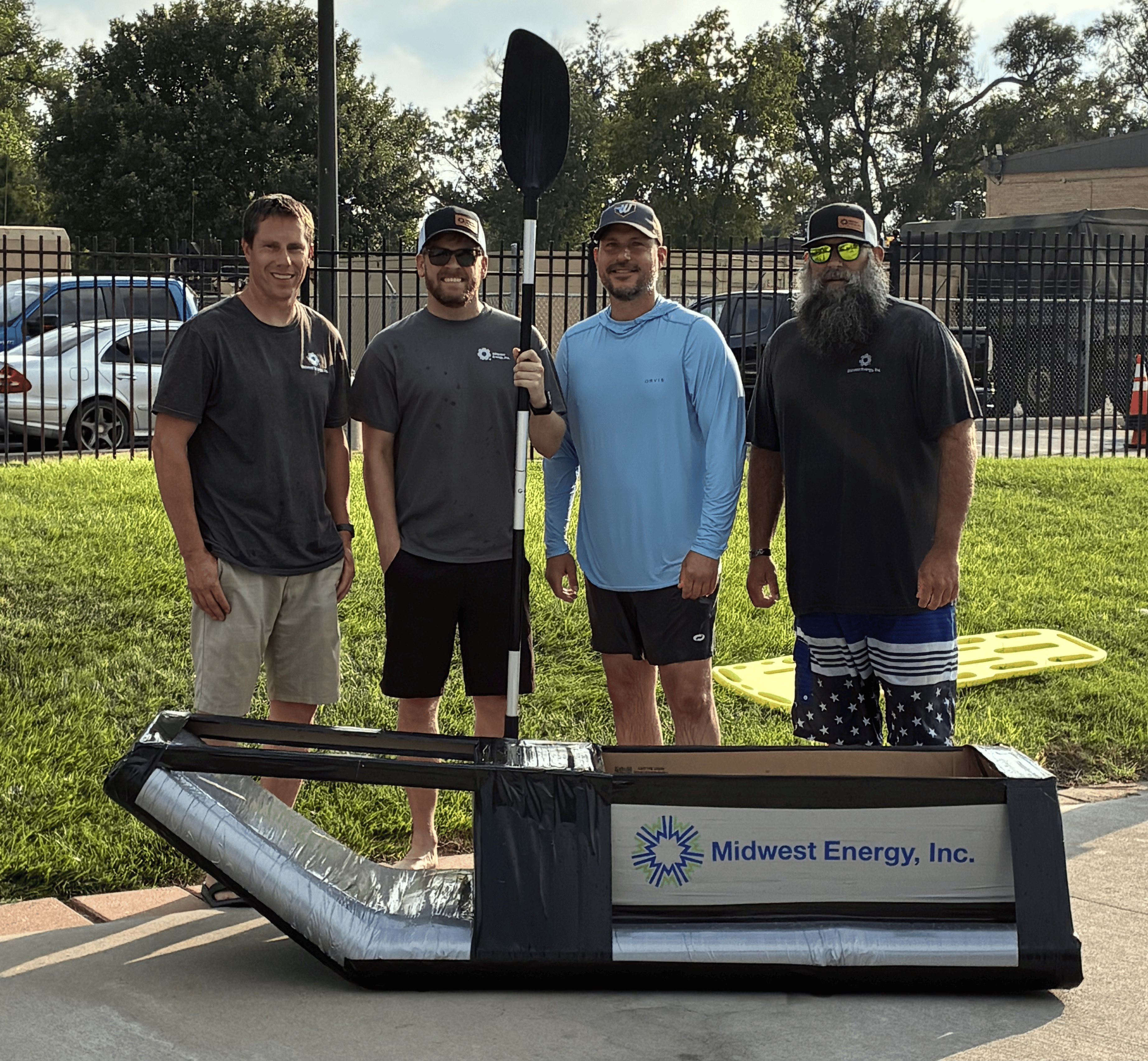 The Midwest Energy team posing for a picture after winning the Sink or Sail Cardboard Regatta at the Hays Duck Derby. From left: Curtis Moore, Rick Staples, Brett Gerber and Jared Wickham.