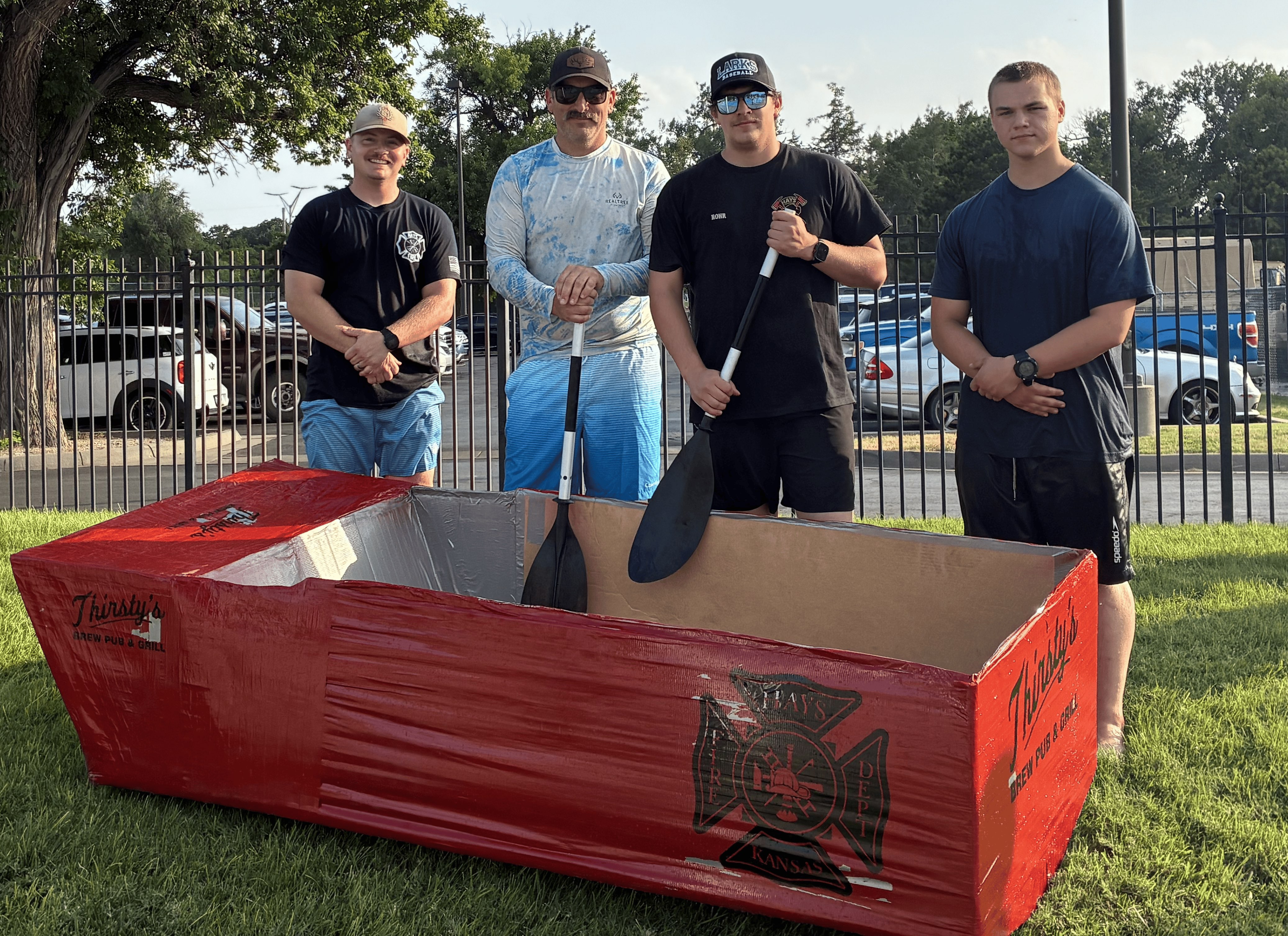 The Hays Fire Department team posing for a picture after placing second in the Sink or Sail Cardboard Regatta. From left: Channing Rutherford, Grady Keith, Eli Rohr and Tyler Maulding