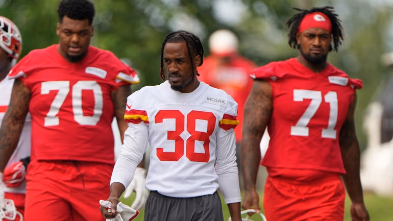 Kansas City Chiefs tackle Kahil Benson (70), cornerback L'Jarius Sneed (38) and tackle Josh Simmons (71) arrive at NFL football training camp Wednesday, July 29, 2026, in St. Joseph, Mo. (AP Photo/Charlie Riedel)