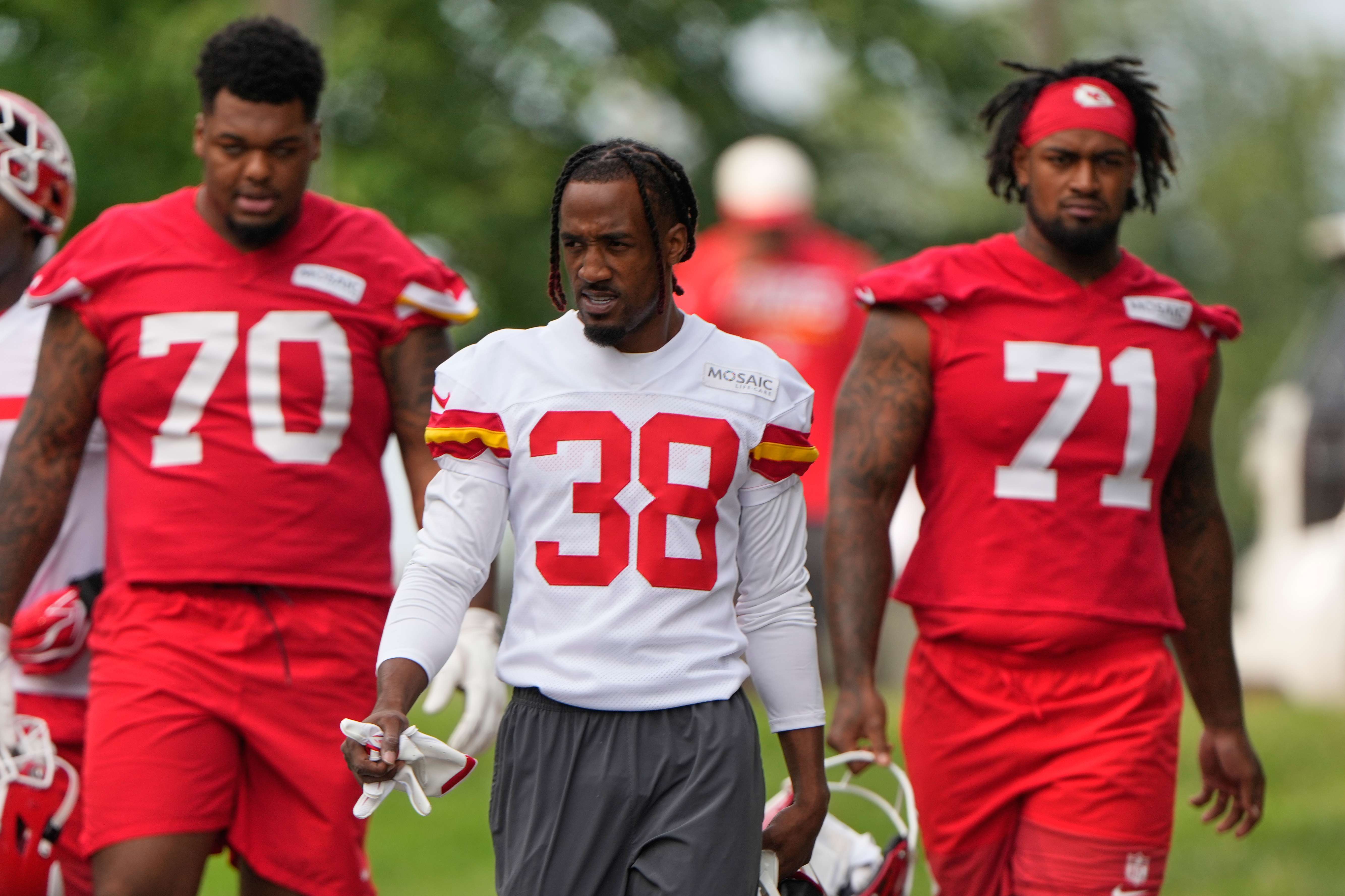 Kansas City Chiefs tackle Kahil Benson (70), cornerback L'Jarius Sneed (38) and tackle Josh Simmons (71) arrive at NFL football training camp Wednesday, July 29, 2026, in St. Joseph, Mo. (AP Photo/Charlie Riedel)