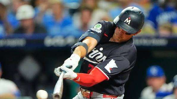 Minnesota Twins' Brooks Lee hits a two-run single during the eighth inning of a baseball game against the Kansas City Royals, Thursday, Aug. 6, 2026, in Kansas City, Mo. (AP Photo/Charlie Riedel)