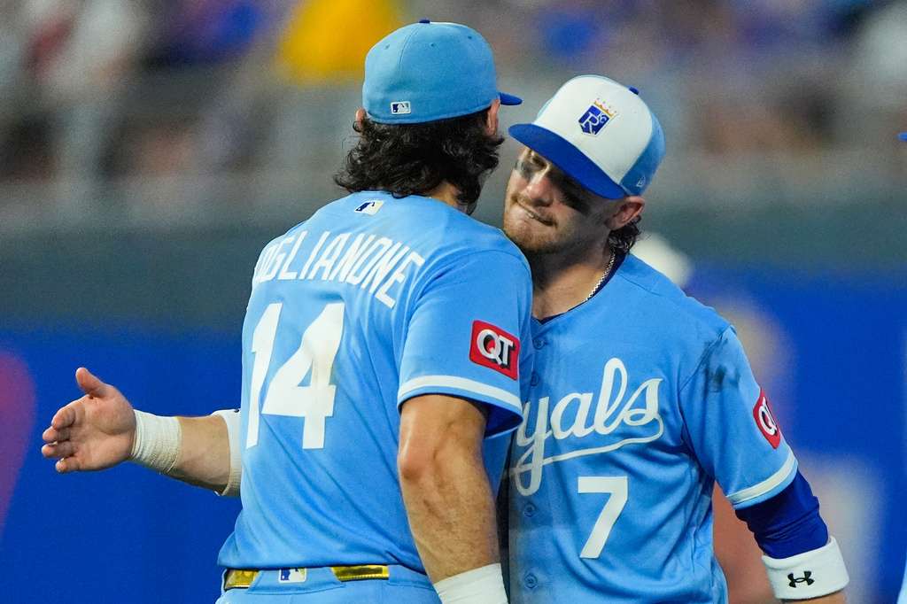 Kansas City Royals' Jac Caglianone (14) and Bobby Witt Jr. (7) celebrate after their baseball game against the Chicago Cubs, Saturday, Aug. 8, 2026, in Kansas City, Mo. (AP Photo/Charlie Riedel)