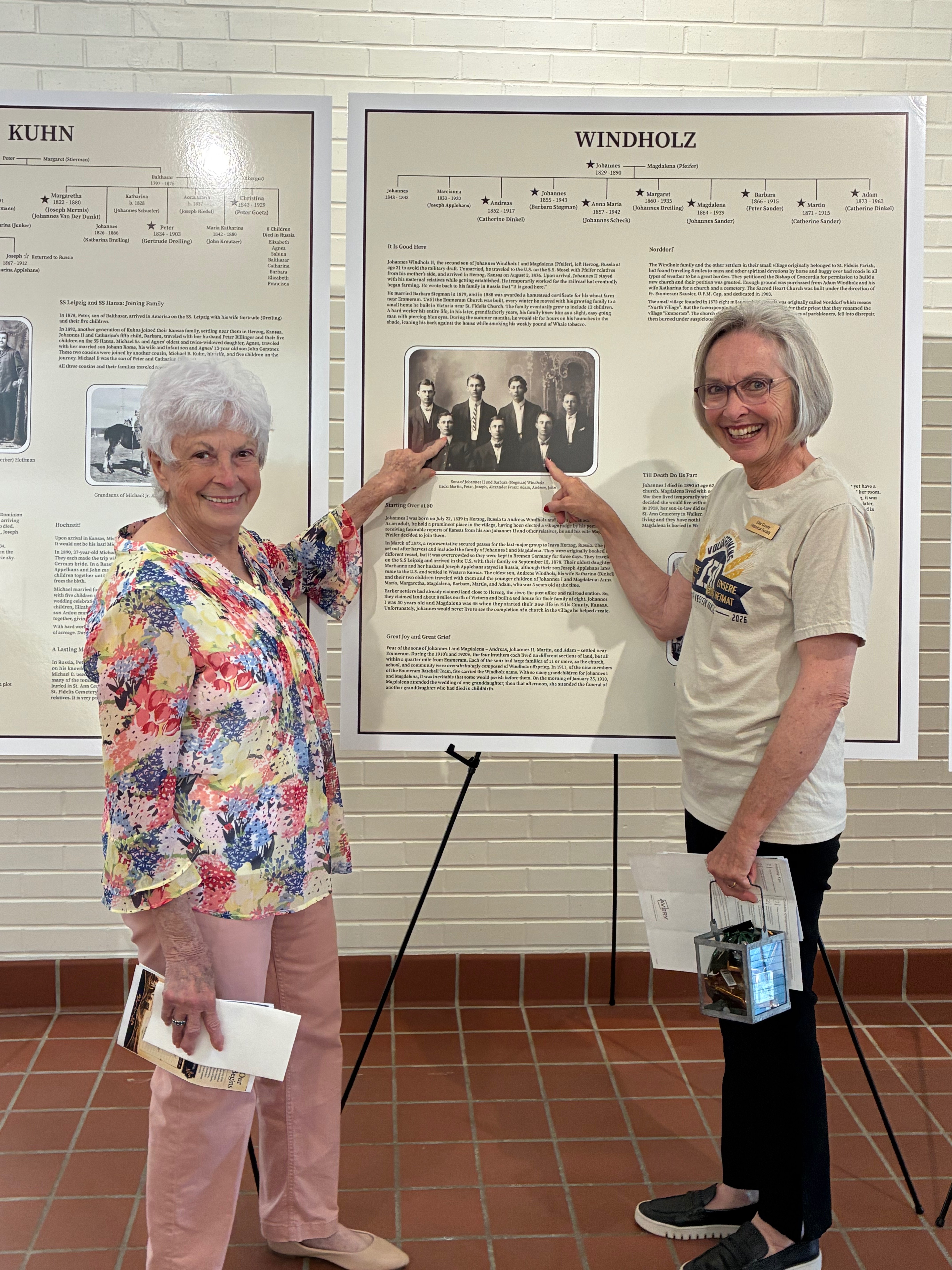 Betty Davis, left and Mary Kay Schippers, right, point to their grandfathers on the Windholz Volga German family tree during the Ellis County Historical Society Heritage Center open house. Photo by Alin Hett/Hays Post