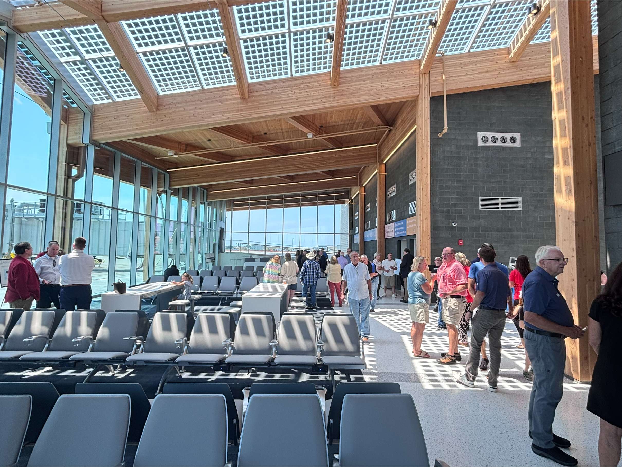 Visitors tour the new passenger terminal at North Platte Regional Airport during Monday’s grand opening. The new facility features expanded seating, large windows, natural light and a jet bridge connecting passengers directly to aircraft. (Allison Peck | The Post)