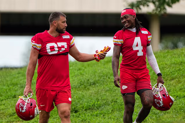 Kansas City Chiefs tight end Travis Kelce (87), and wide receiver Rashee Rice (4) walk to NFL football training camp Friday, July 31, 2026, in St. Joseph, Mo. (AP Photo/Charlie Riedel)