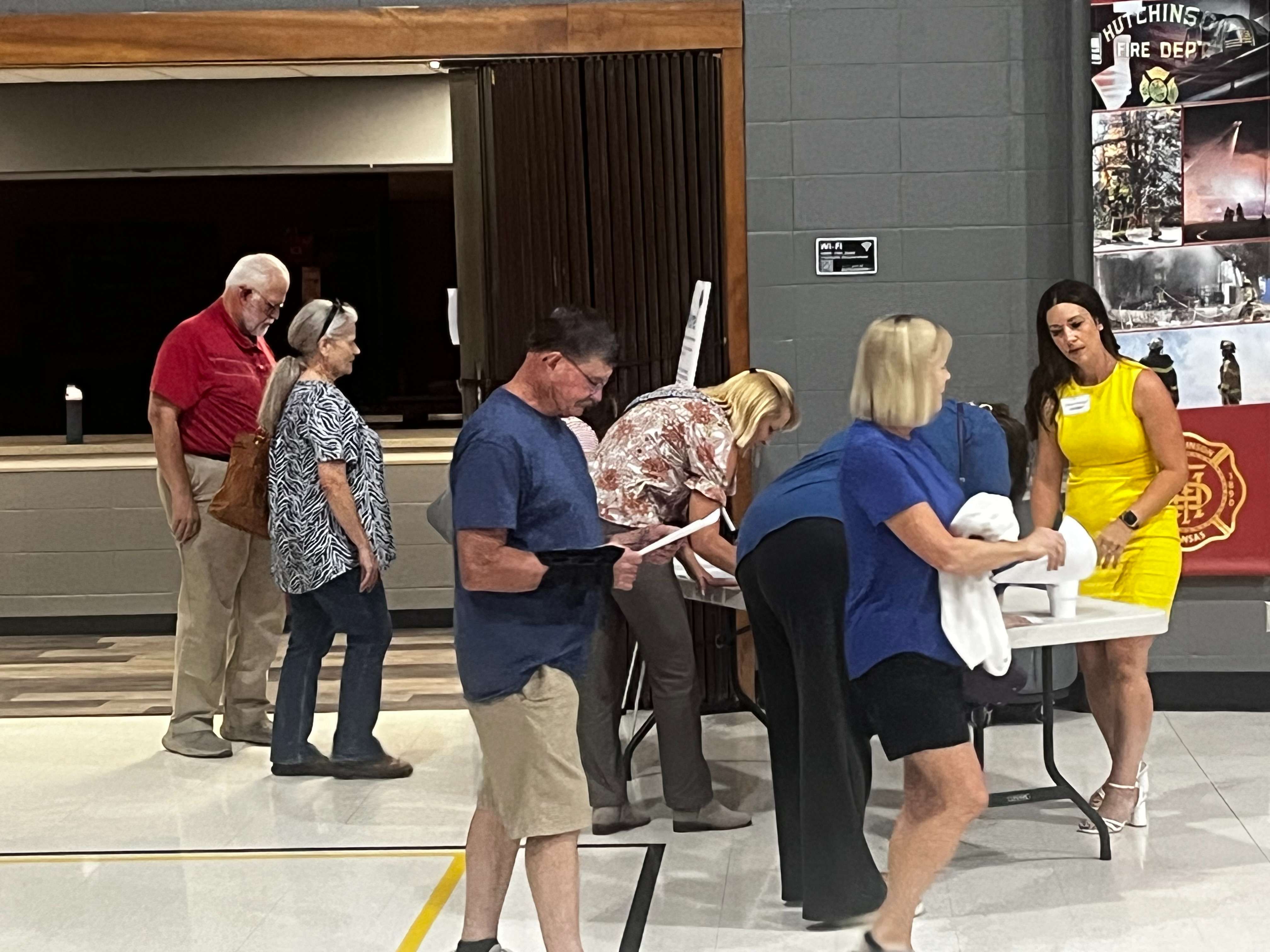 People sign in as they arrive at the Data Center Open House on Wednesday evening. (Hutch Post photo)