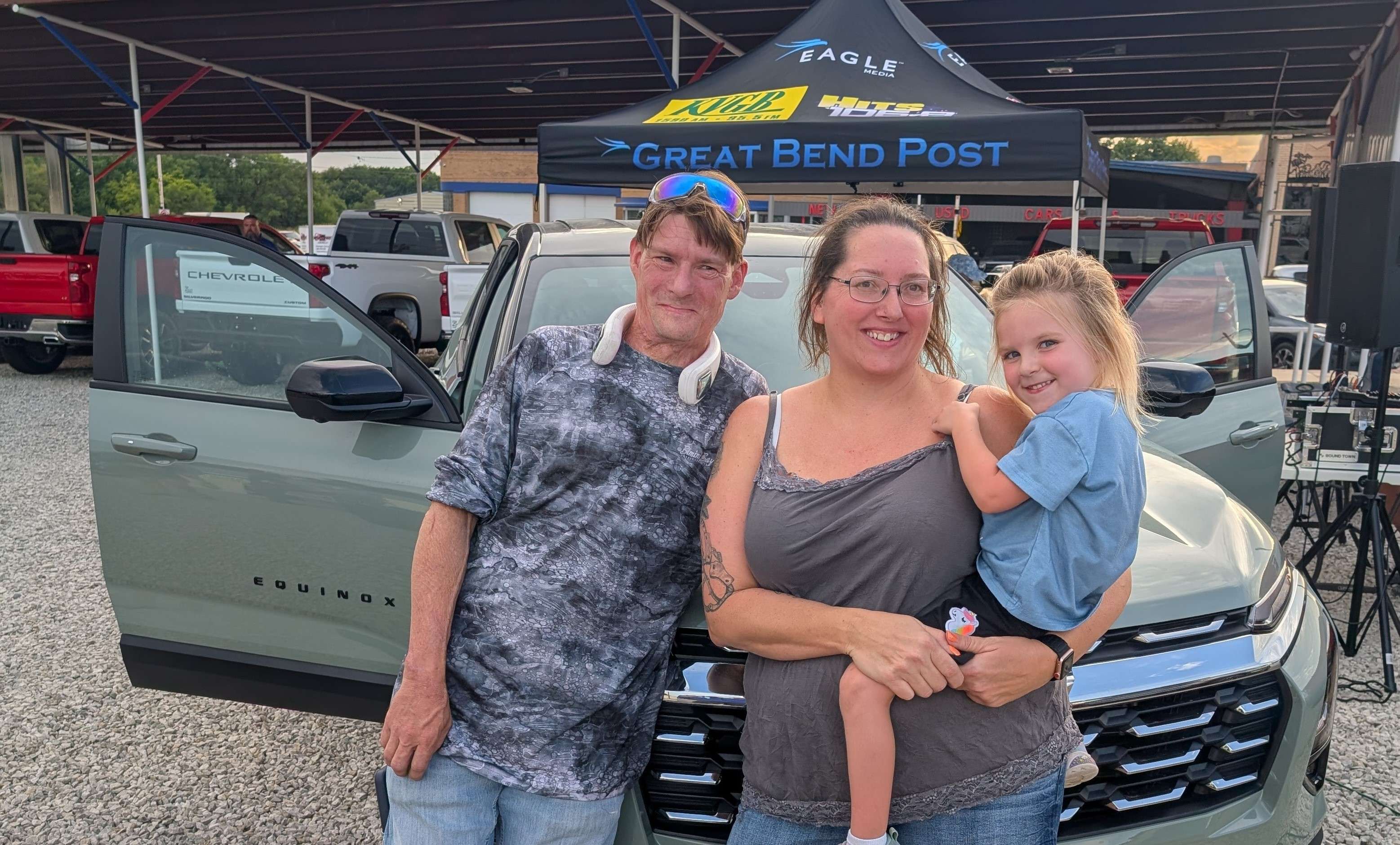 Great Bend's Brandy Lang, with Chris LaBranche and granddaughter Renesmee Griffin, is the winner of Eagle Media's Looking Fly in a Cacti Summer Giveaway, presented by Ehler Chevrolet, Equity Bank, Eldridge Fencing, and Z's Liquor &amp; Z's Liquormart.