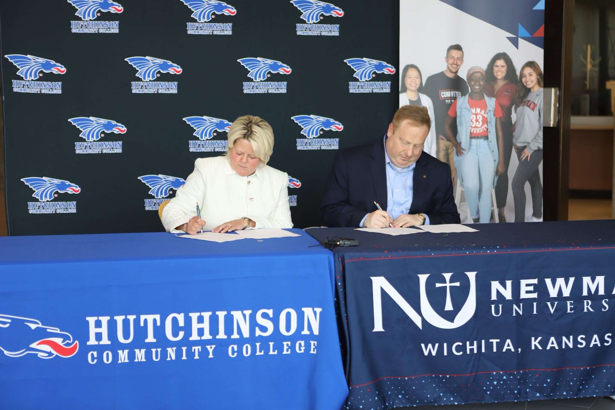HutchCC President Tricia Paramore L) and Newman University Vice President for Student Affairs sign a Memorandum Of Understanding establishing the HERE Partnership on Aug. 14, 2025. (Photo Courtesy Newman University)