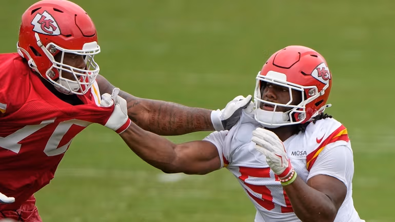 Kansas City Chiefs tackle Kahil Benson, left, and Kansas City Chiefs defensive end R Mason Thomas (51) practice during NFL football training camp Friday, July 31, 2026, in St. Joseph, Mo. (AP Photo/Charlie Riedel)