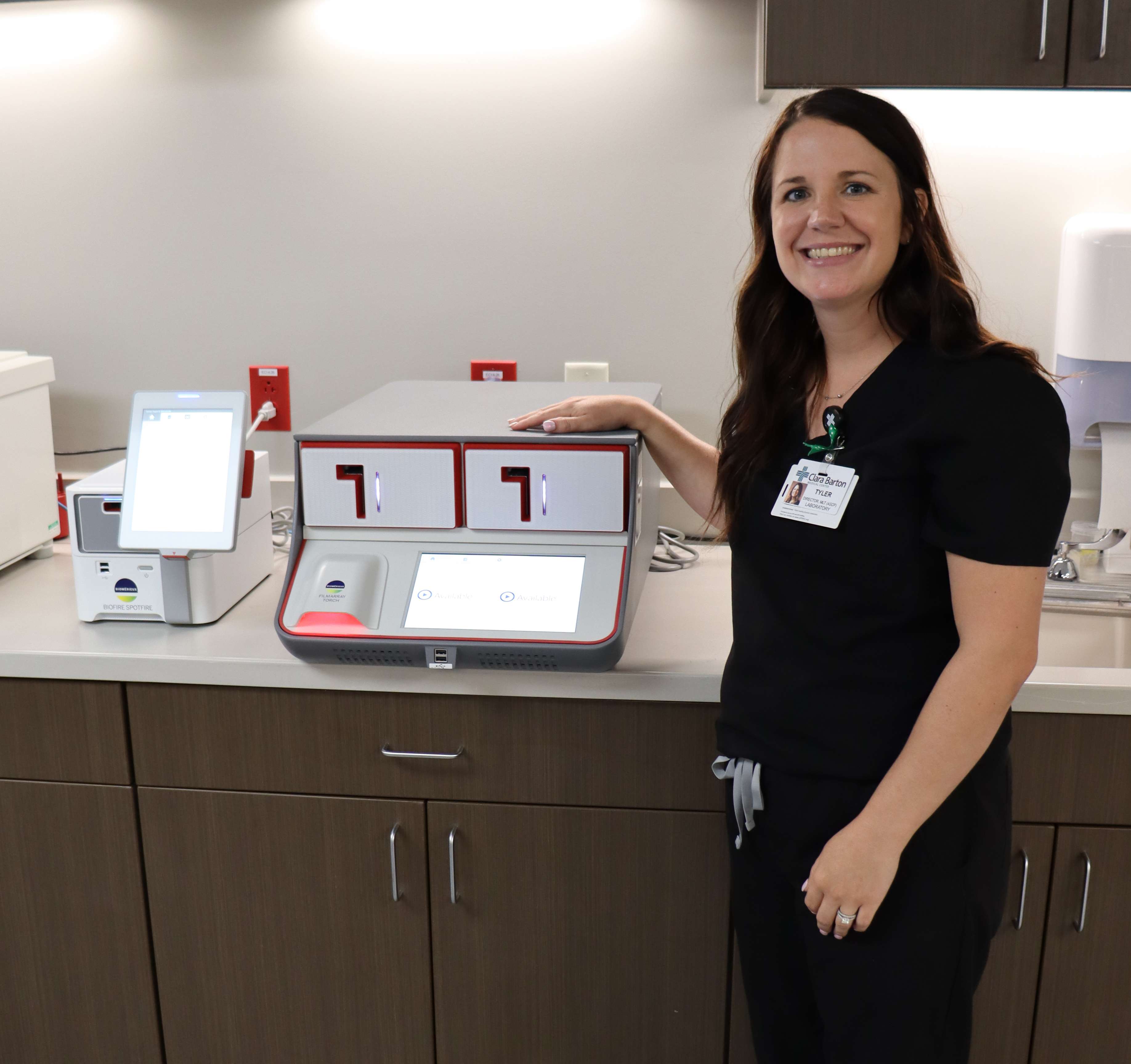 Laboratory Director Tyler Schremmer poses with the new BioFire rapid infectious disease diagnostic system, funded through proceeds from the Clara Barton Foundation’s Annual Benefit. The event generated $107,800 in net proceeds to support the system, helping expand the hospital’s in-house testing capabilities and provide faster diagnostic results.