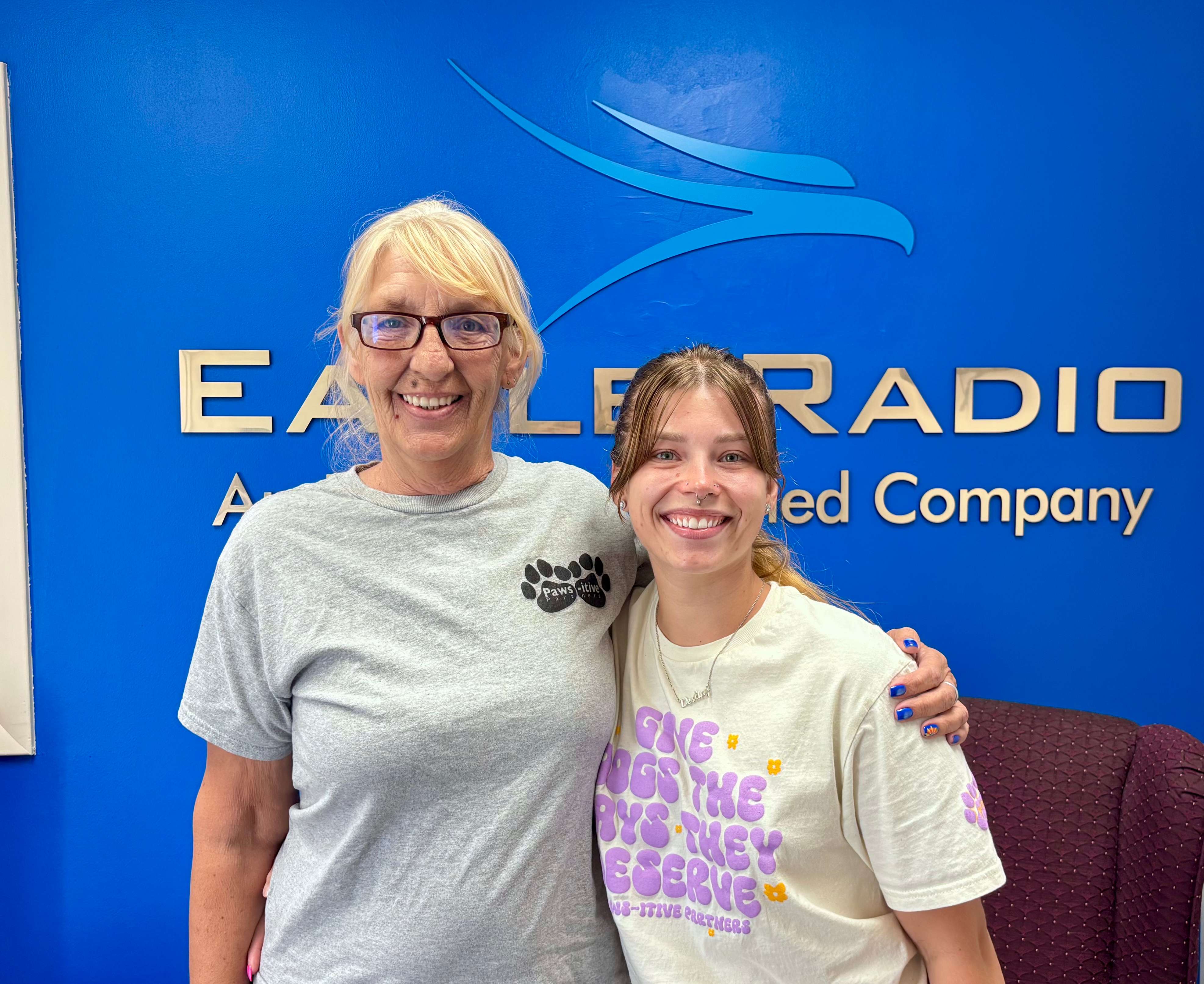 PAWS-itive Partners members Melissa Walker, left, and Destiny Malcolm, right, visit the Eagle Radio studios to discuss Woofstock 2026, a dog-friendly fundraiser taking place Saturday, August 22, at Memorial Park in North Platte.