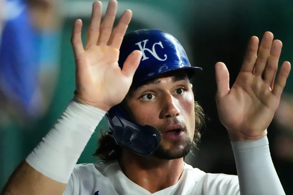 Kansas City Royals' Jac Caglianone celebrates in the dugout after scoring on a double hit by Vinnie Pasquantino during the seventh inning of a baseball game against the Athletics, Tuesday, Aug. 18, 2026, in Kansas City, Mo. (AP Photo/Charlie Riedel)