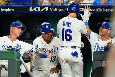 Kansas City Royals' John Rave (16) celebrates in the dugout after scoring on a single by Miakel Garcia during the eighth inning of a baseball game against the Athletics, Wednesday, Aug. 19, 2026, in Kansas City, Mo. (AP Photo/Charlie Riedel)