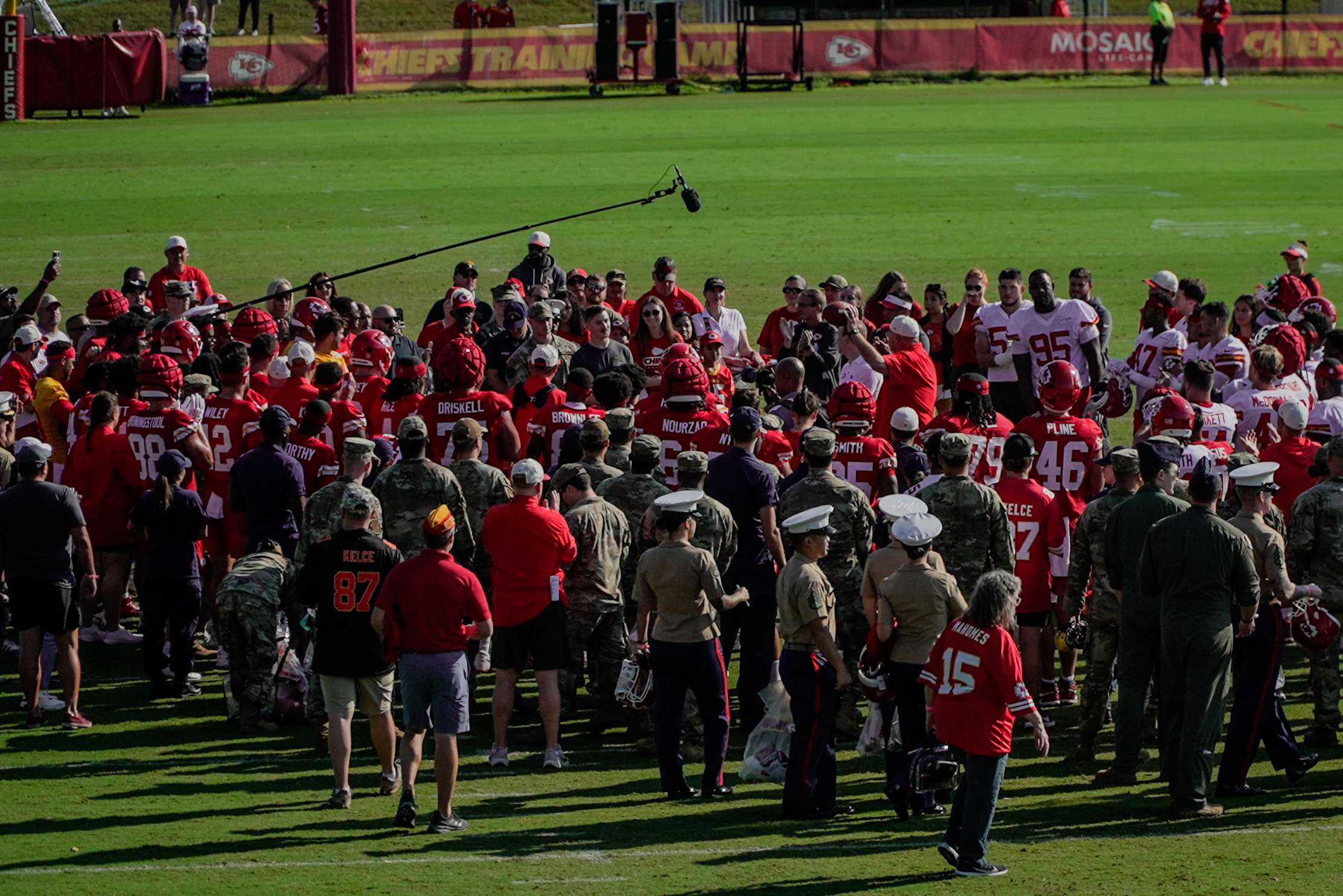 Head Coach Andy Reid presents a game ball to military members during the final huddle of Chiefs Training Camp in St. Joseph on the Missouri Western campus/ Photo by Justin Peacock