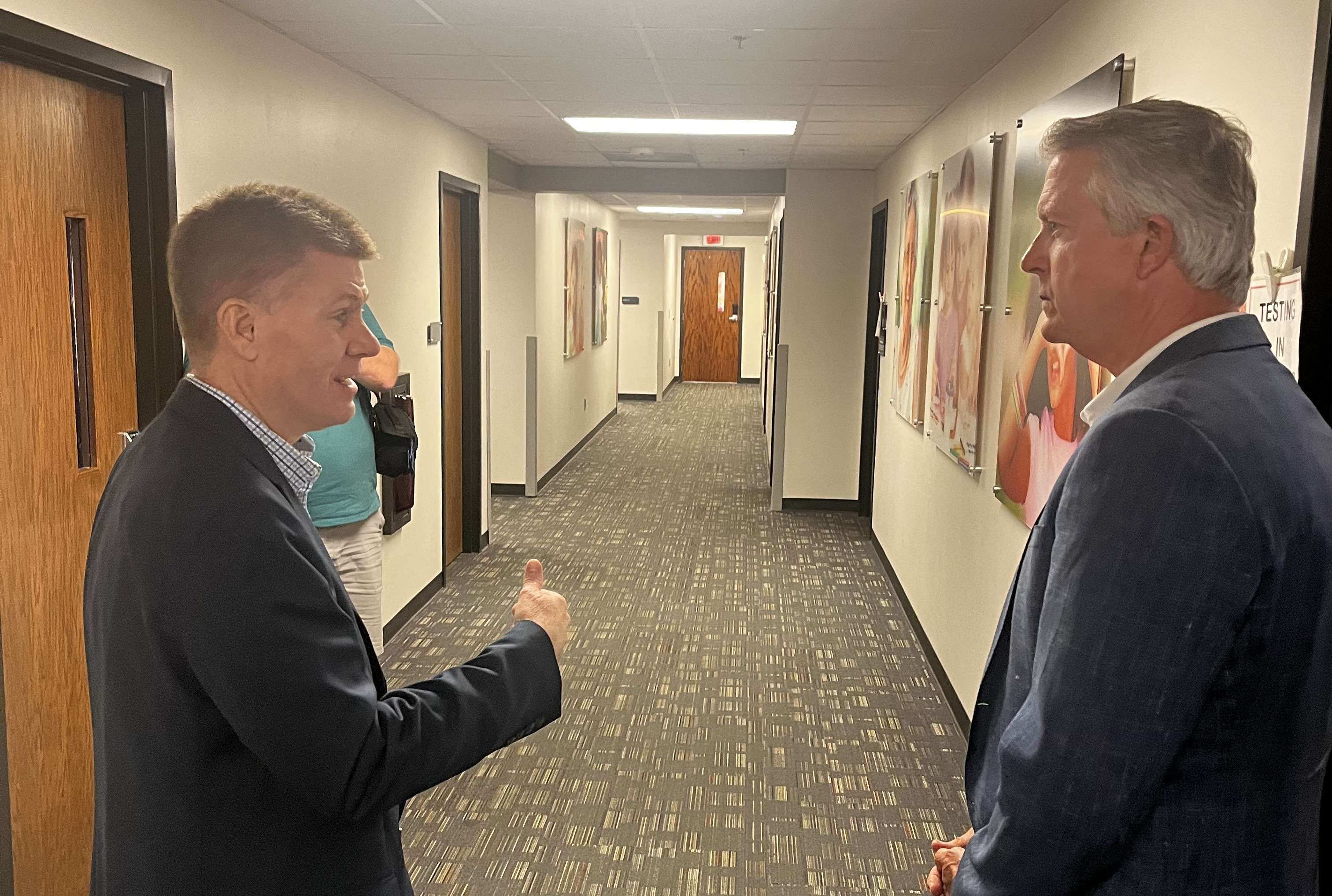 PrairieStar Health Center CEO Bryant Anderson (L) visits with US Senator Roger Marshall during a tour of the health center on Aug. 20, 0206. (Hutch Post photo)