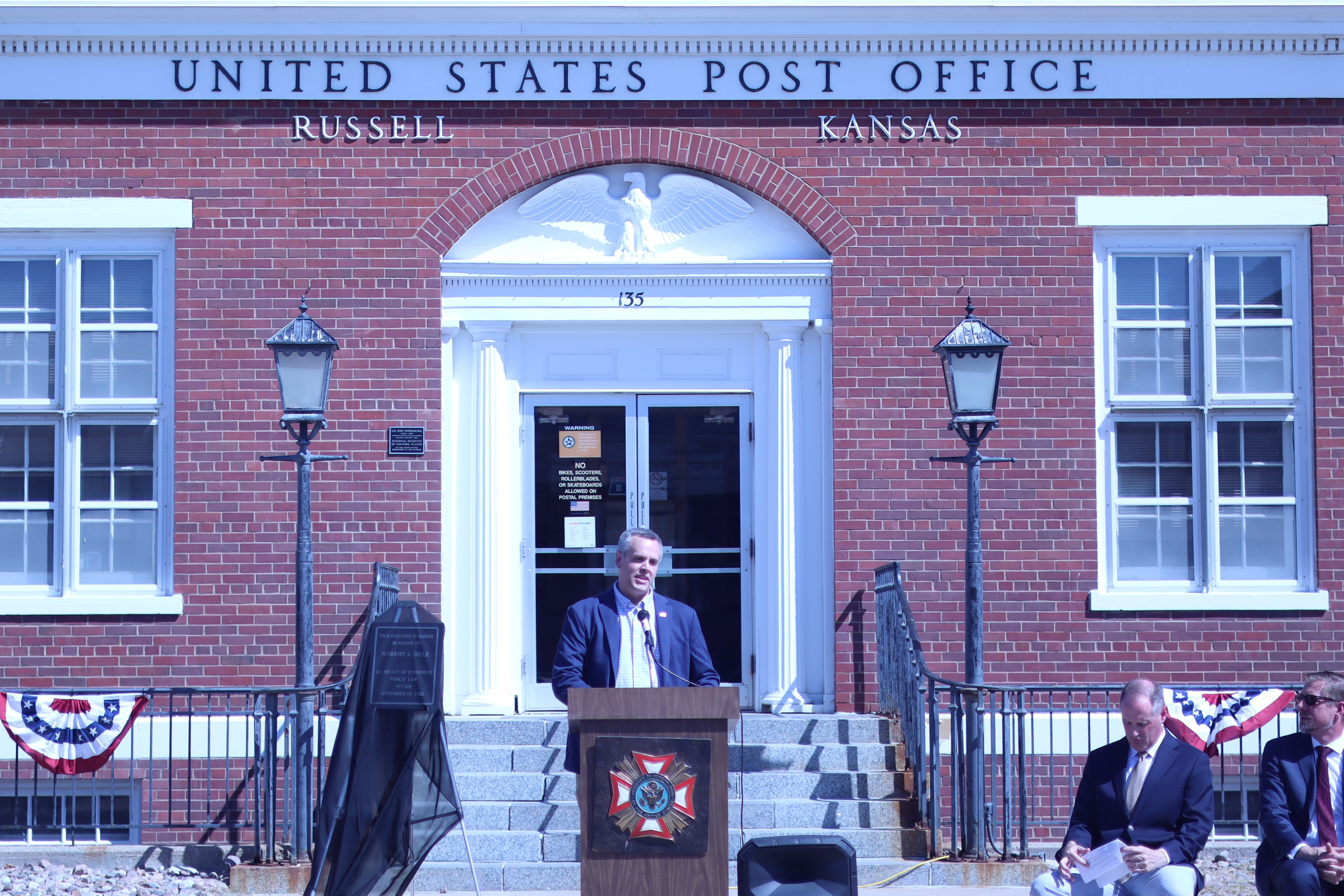 Reed Petty speaks on behalf of U.S. Sen. Jerry Moran during the ceremony honoring Bob Dole in Russell.<br>