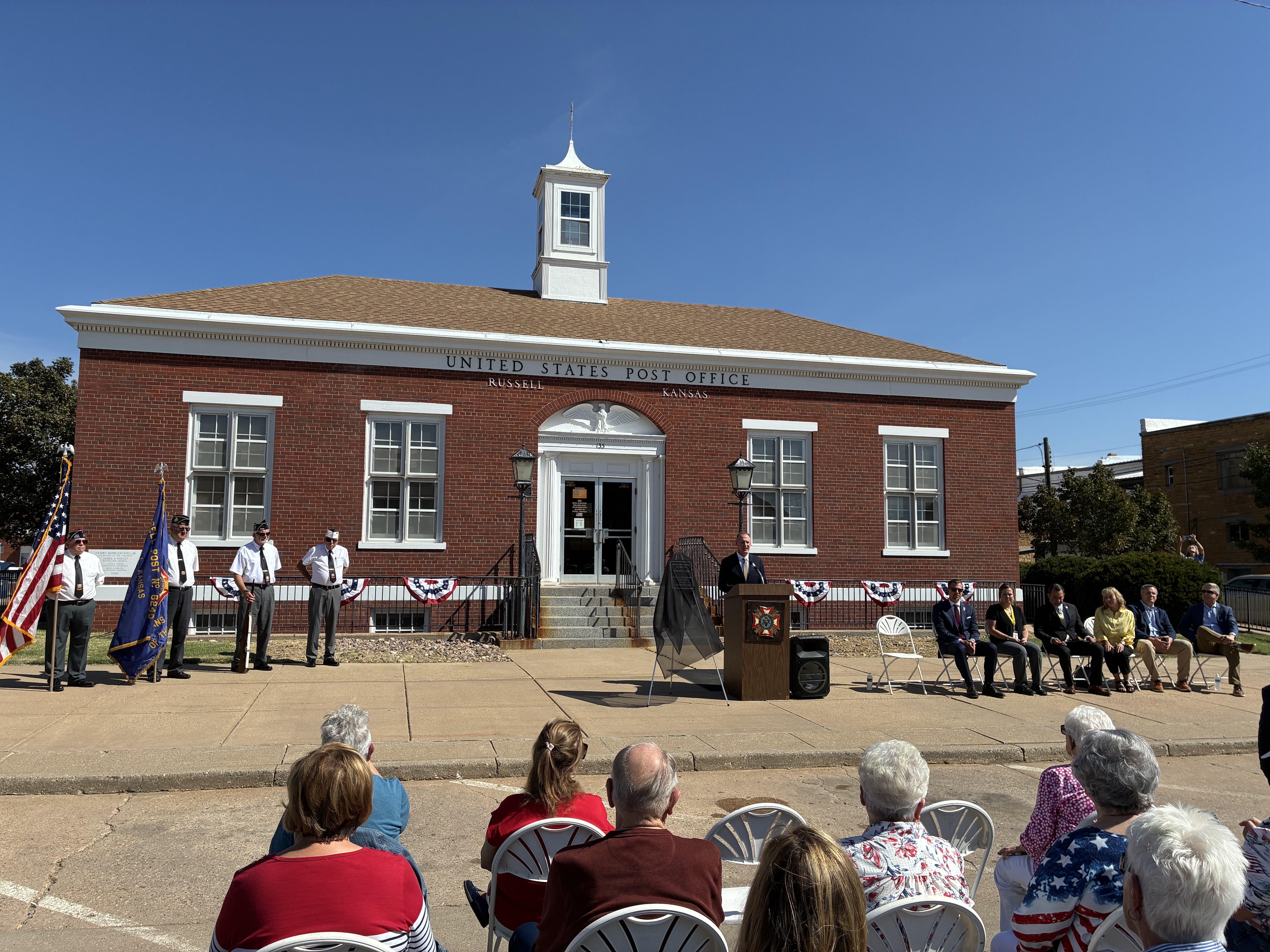 A color guard and congressional representatives gather in Russell for the ceremony renaming the Russell Post Office after former U.S. Sen. Bob Dole.<br>