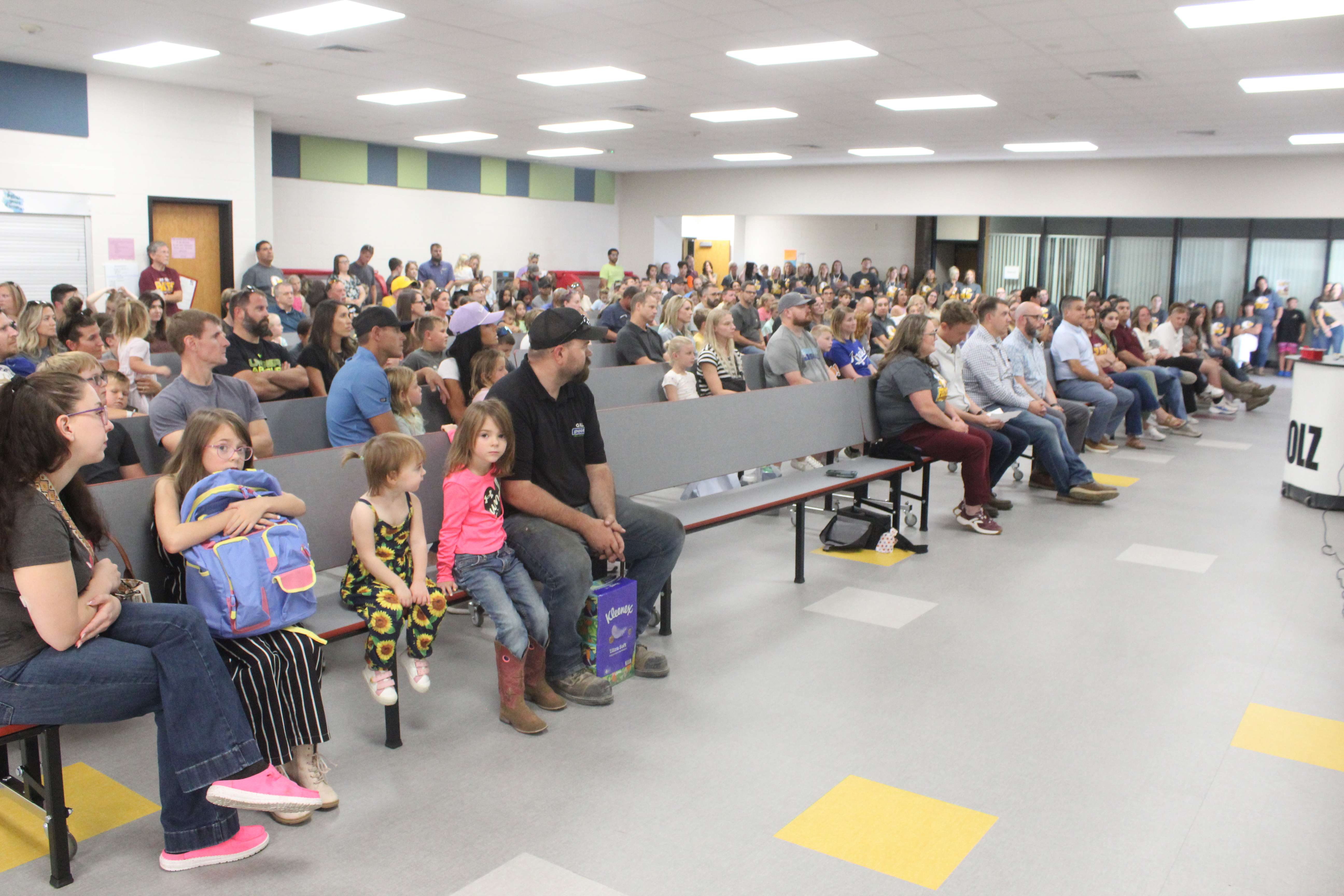 Children, parents, staff and guests gather in the Felten Elementary School cafeteria for a ribbon cutting on Monday. Photo by Cristina Janney/Hays Post