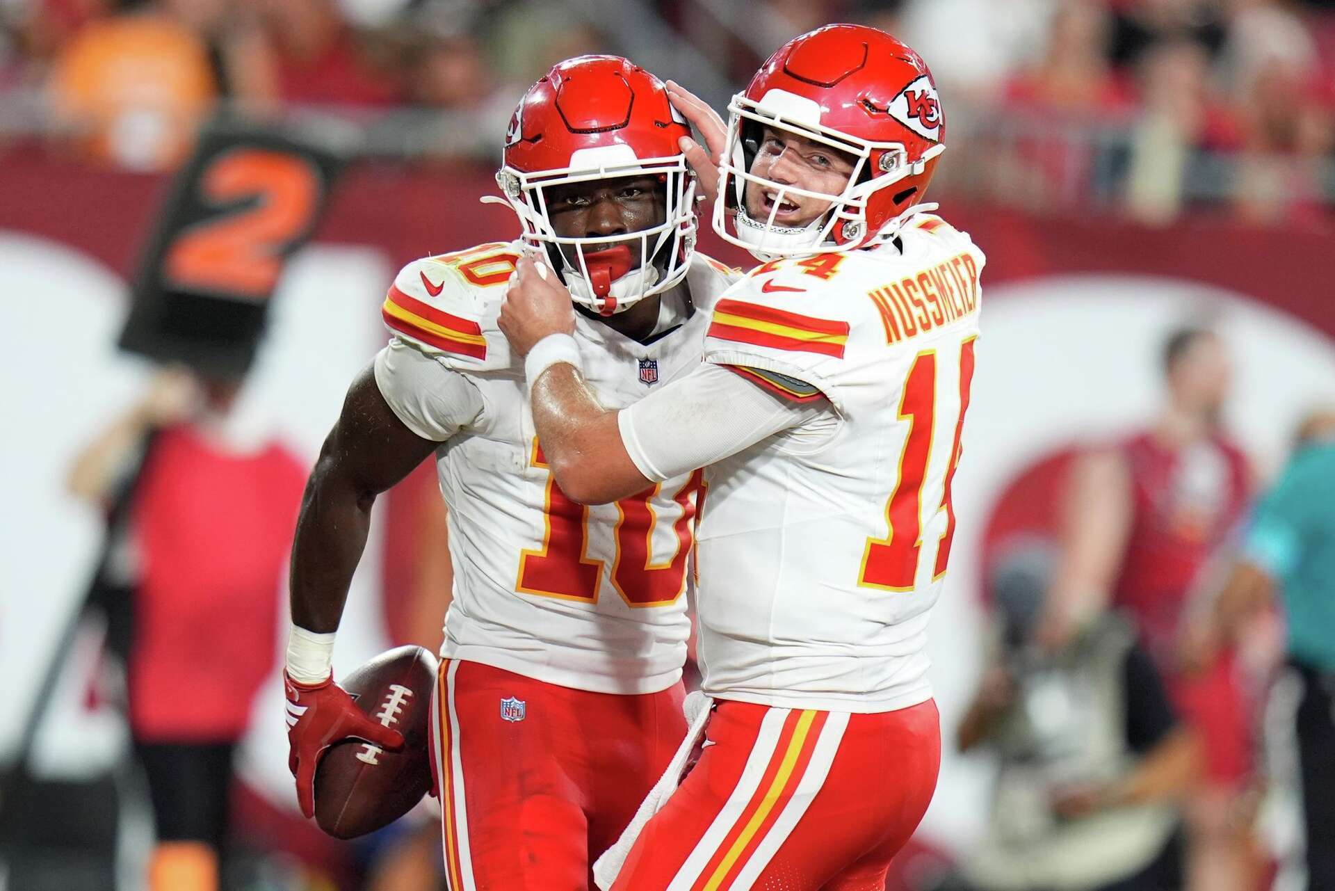 Kansas City Chiefs' Emmett Johnson (10) celebrates a touchdown with quarterback Garrett Nussmeier (14) in the second half of an NFL preseason football game against the Tampa Bay Buccaneers, Saturday, Aug. 22, 2026, in Tampa, Fla. (AP Photo/Chris O'Meara)