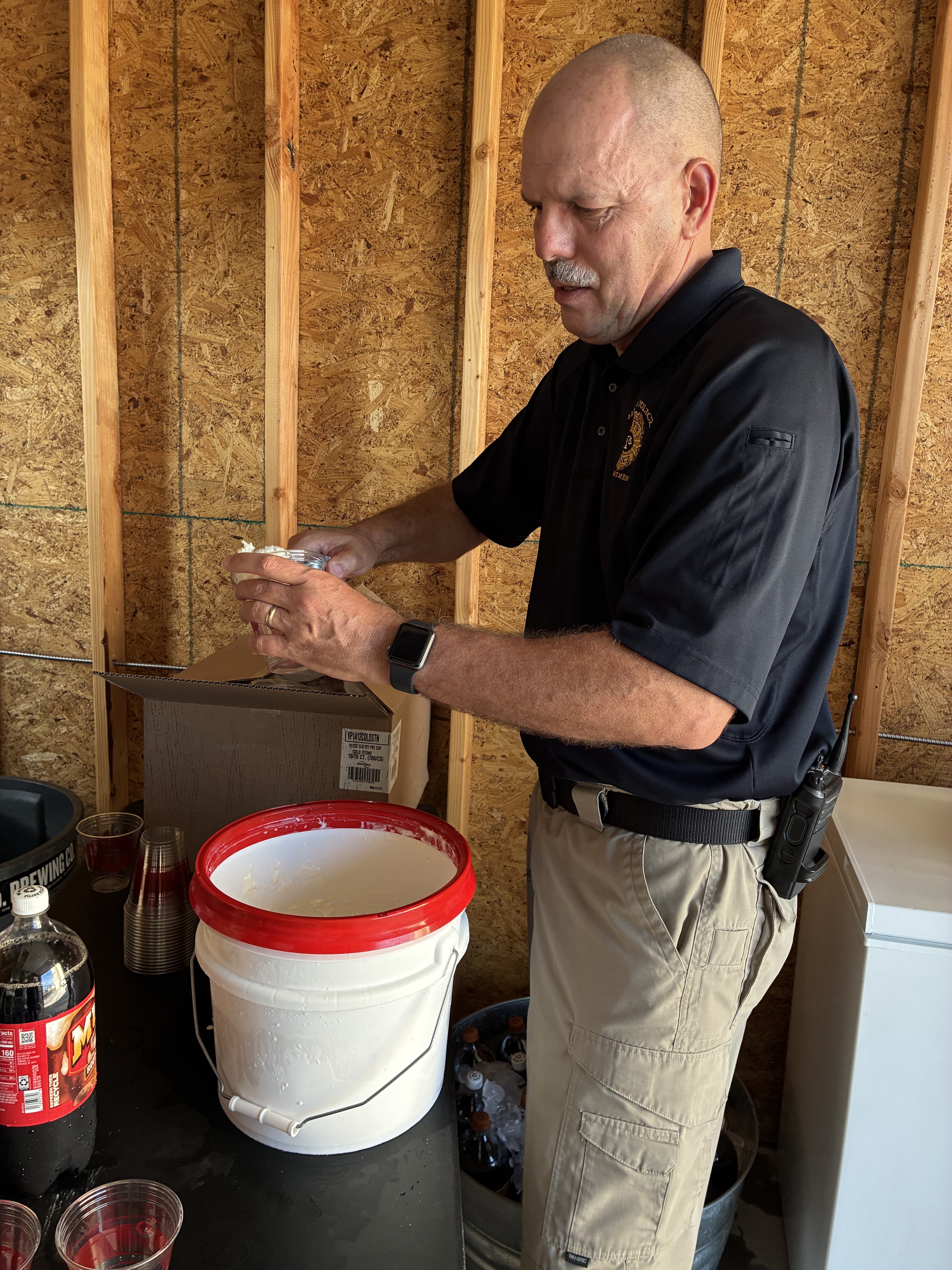 Hays Chief of Police Don Scheibler scooping out vanilla ice cream for the Root Beer Floats during March 2 Main 2026.&nbsp;