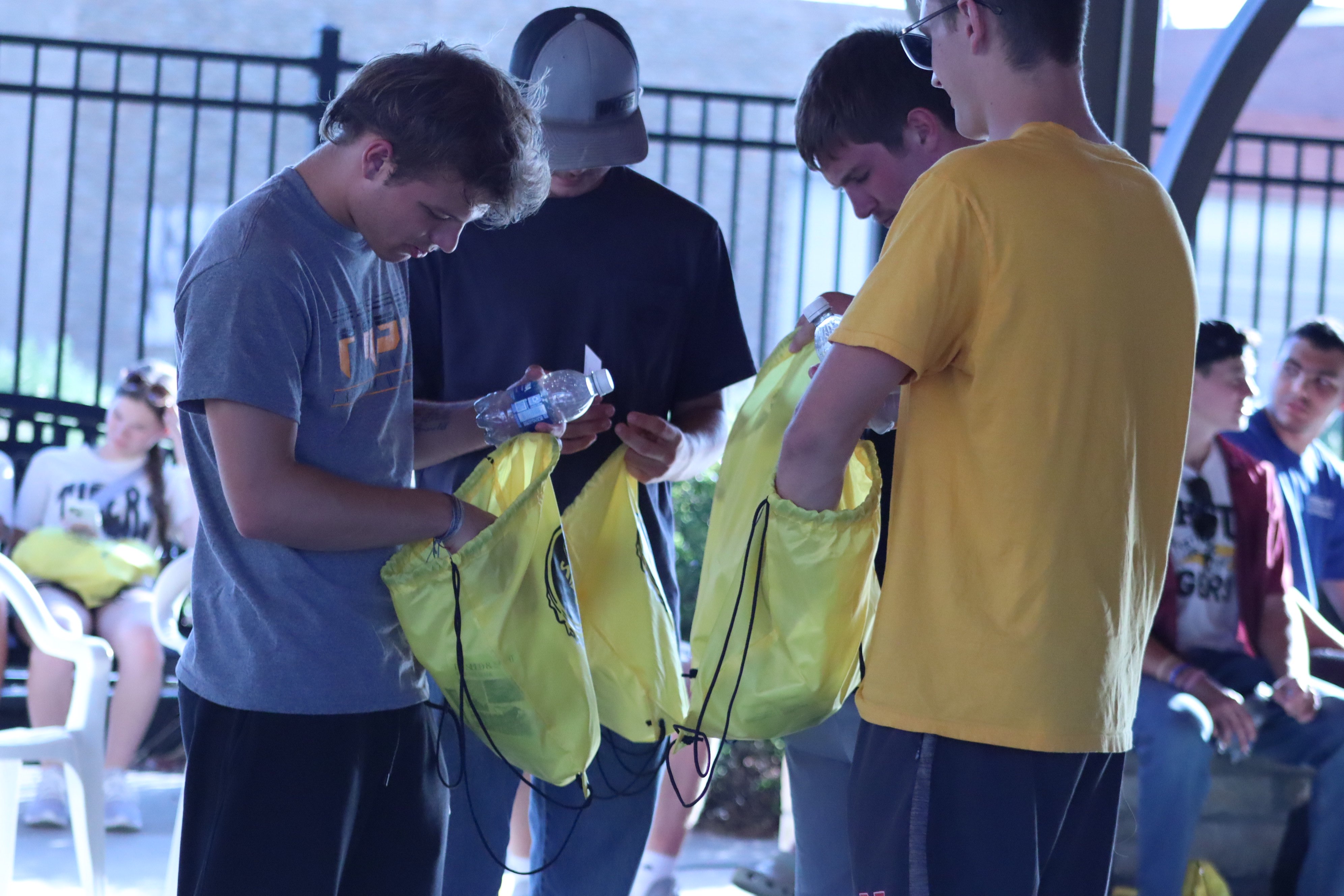 A group of FHSU students look through their newly acquired swag bags during March 2 Main 2026.<br>