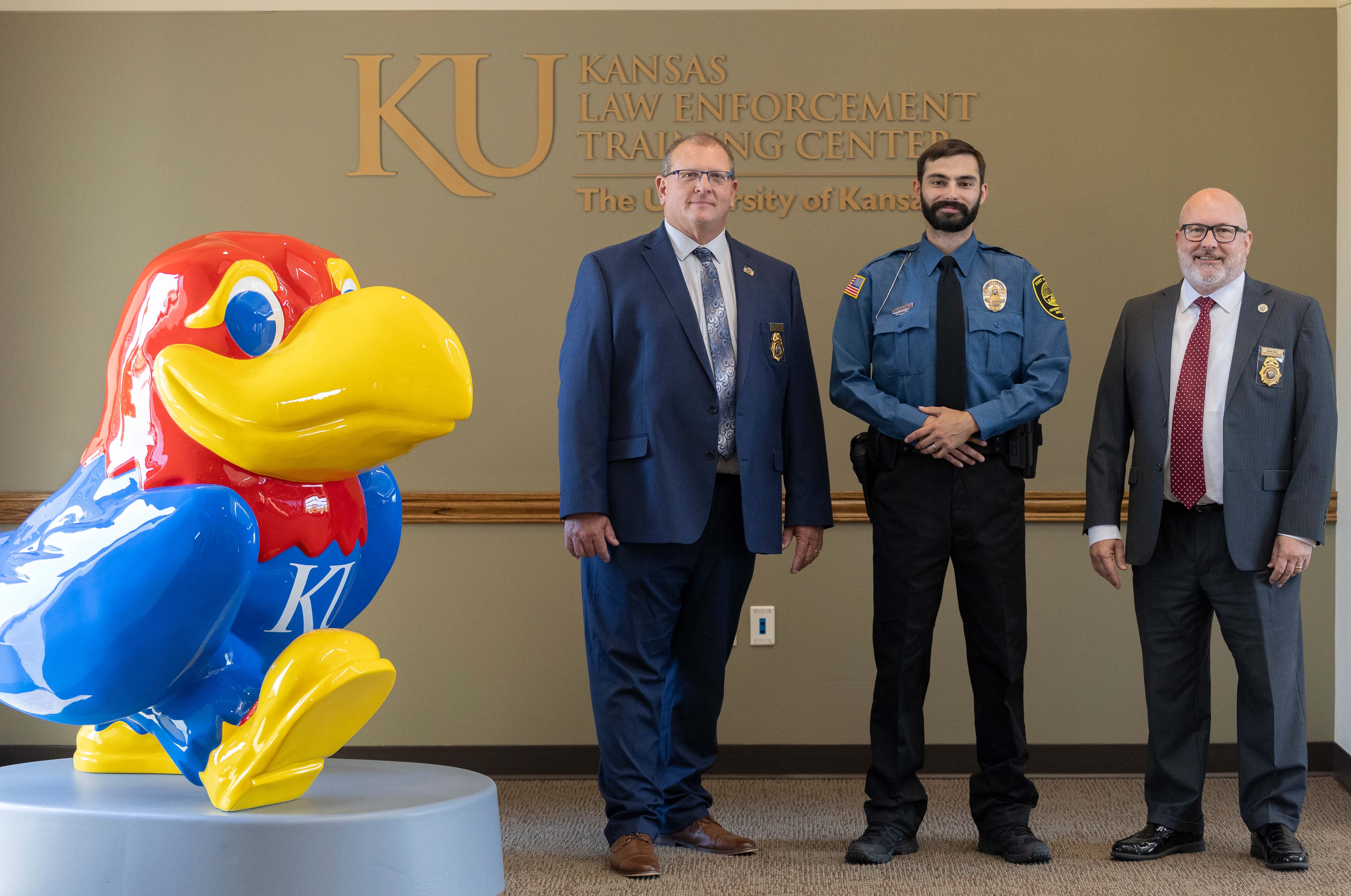 <i>Kansas Law Enforcement Training Center Associate Director Jeff Ostlund, Jake Montgomery, Fort Hays State University police officer and Vice Provost and Director of Police Training Darin Beck. Photo courtesy&nbsp;</i><i>Kansas Law Enforcement Training Center</i>