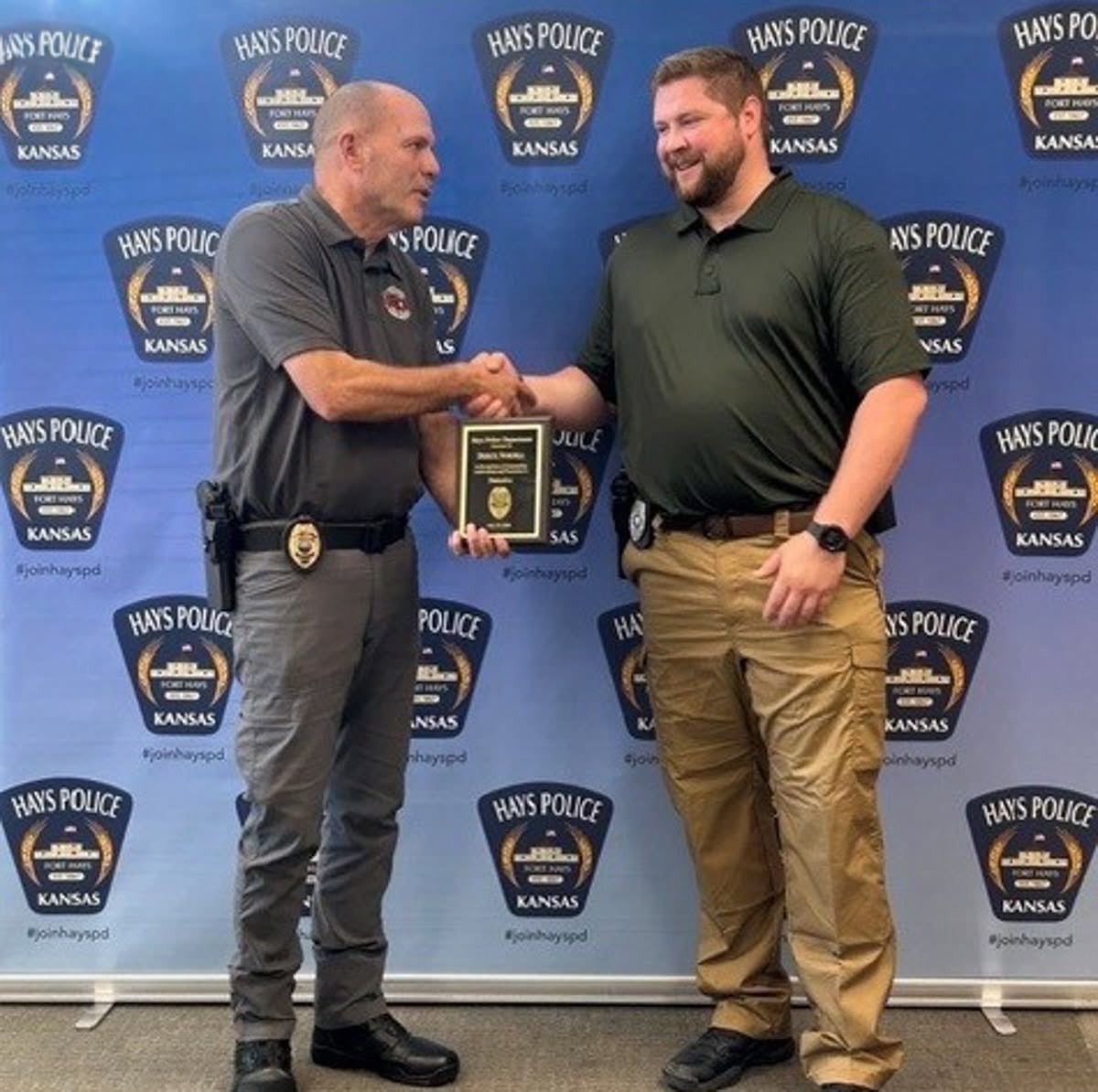 Police Chief Don Scheibler shaking hands with newly promoted detective, Derick Nordell. Courtesy photo&nbsp;