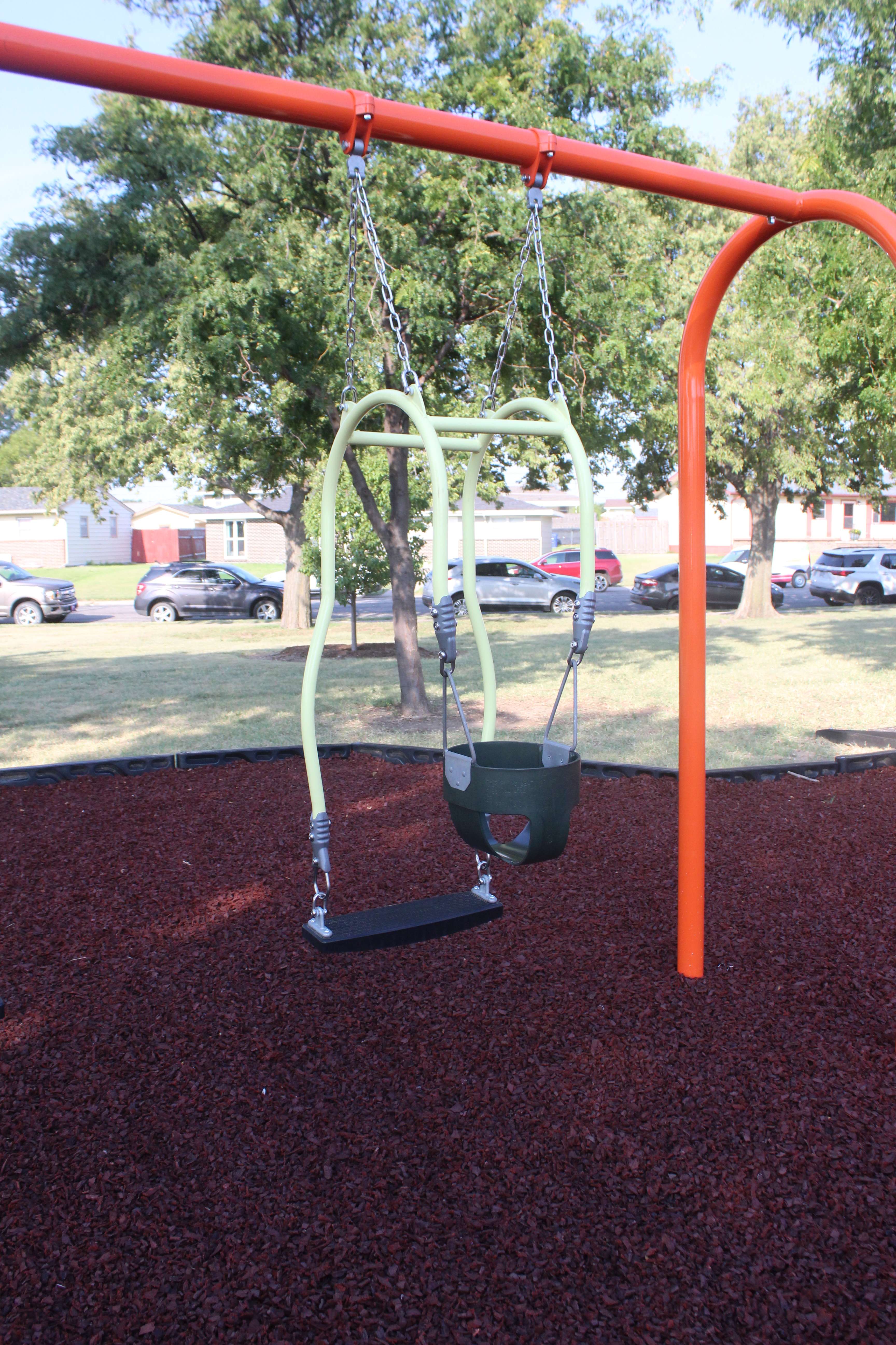 A new mommy-baby swing at Sunrise Park that lets adults and small children swing together, facing each other. Photo by Cristina Janney/Hays Post