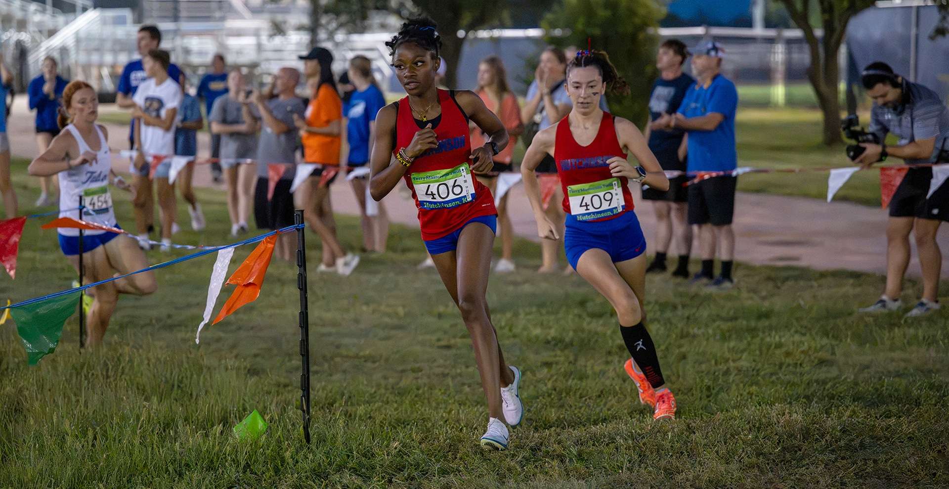 Blue Dragon women's cross country runners Ashara Frater (left) and Kimberlin Lovell (right) finished first and third, respectively, to lead Hutchinson to a team runner-up finish on Thursday at the Terry Masterson Twilight Classic at Fun Valley. (Andrew Carpenter/Digital Fox Photography)