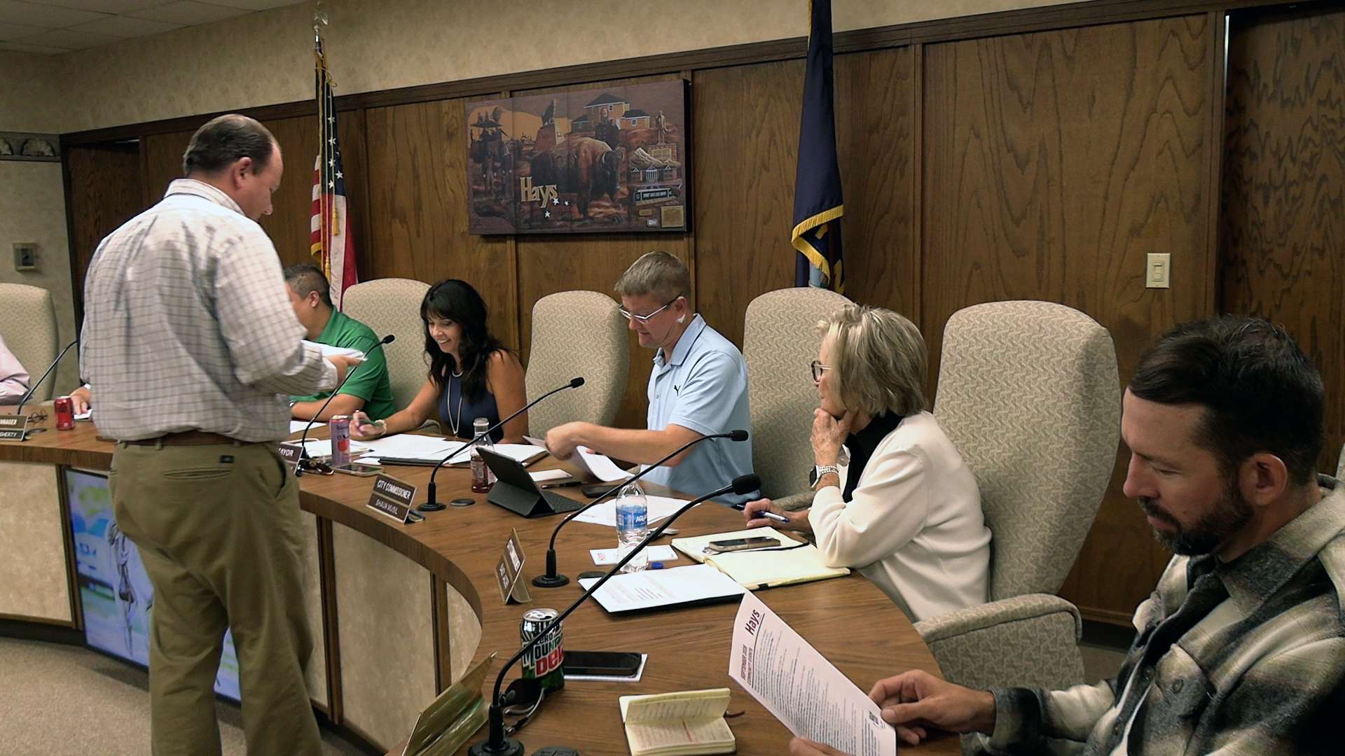 Collin Bielser, Hays deputy city manager, hands out copies of the motion filed by Hays and Russell Thursday in the R9 Ranch water transfer proceedings. Photo by Becky Kiser/Hays Post