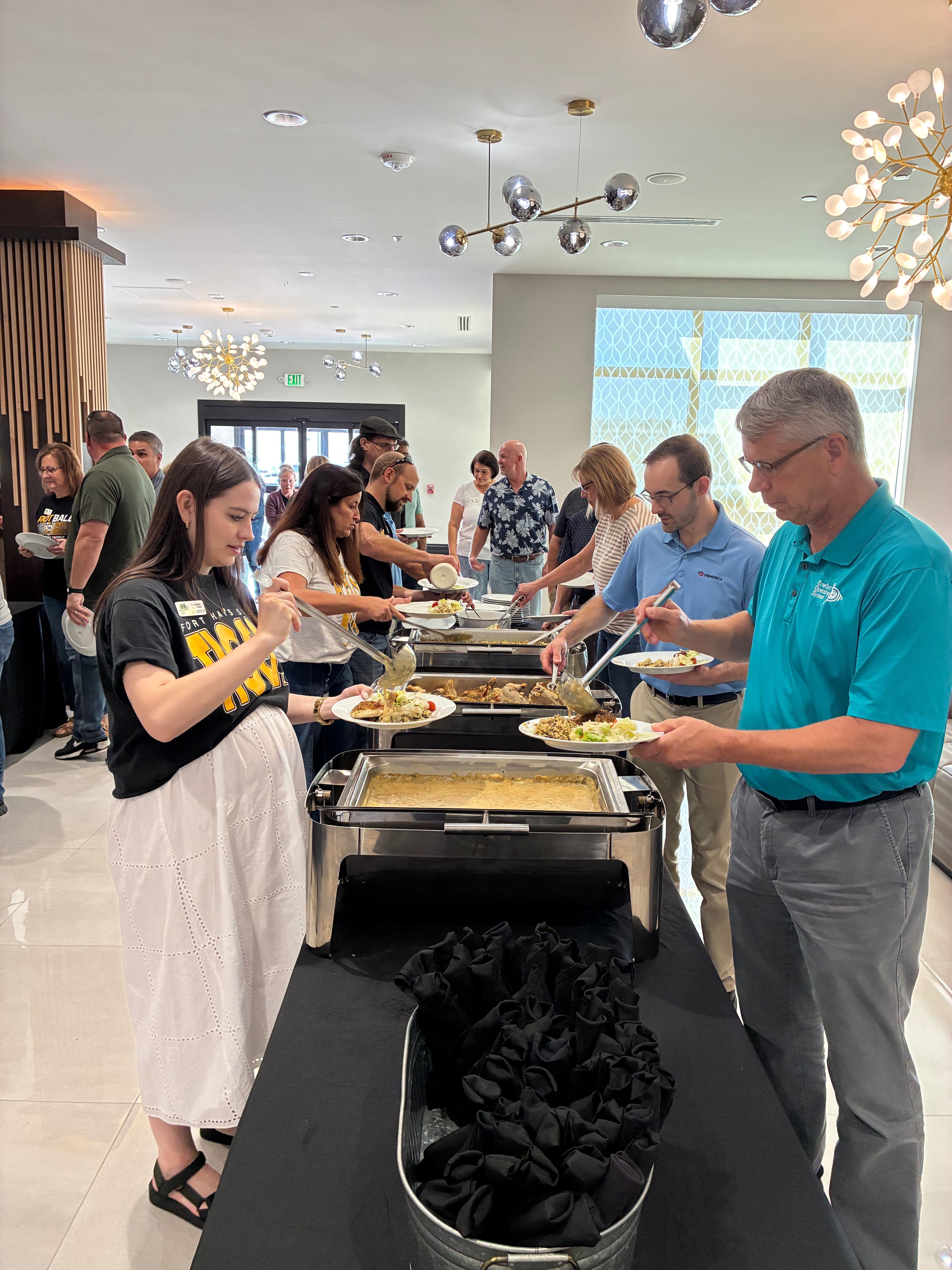 Attendees make their way through the food line during the United Way of Ellis County Kickoff Lunch on Friday in Hays. Photo by Alin Hett/Hays Post<br>
