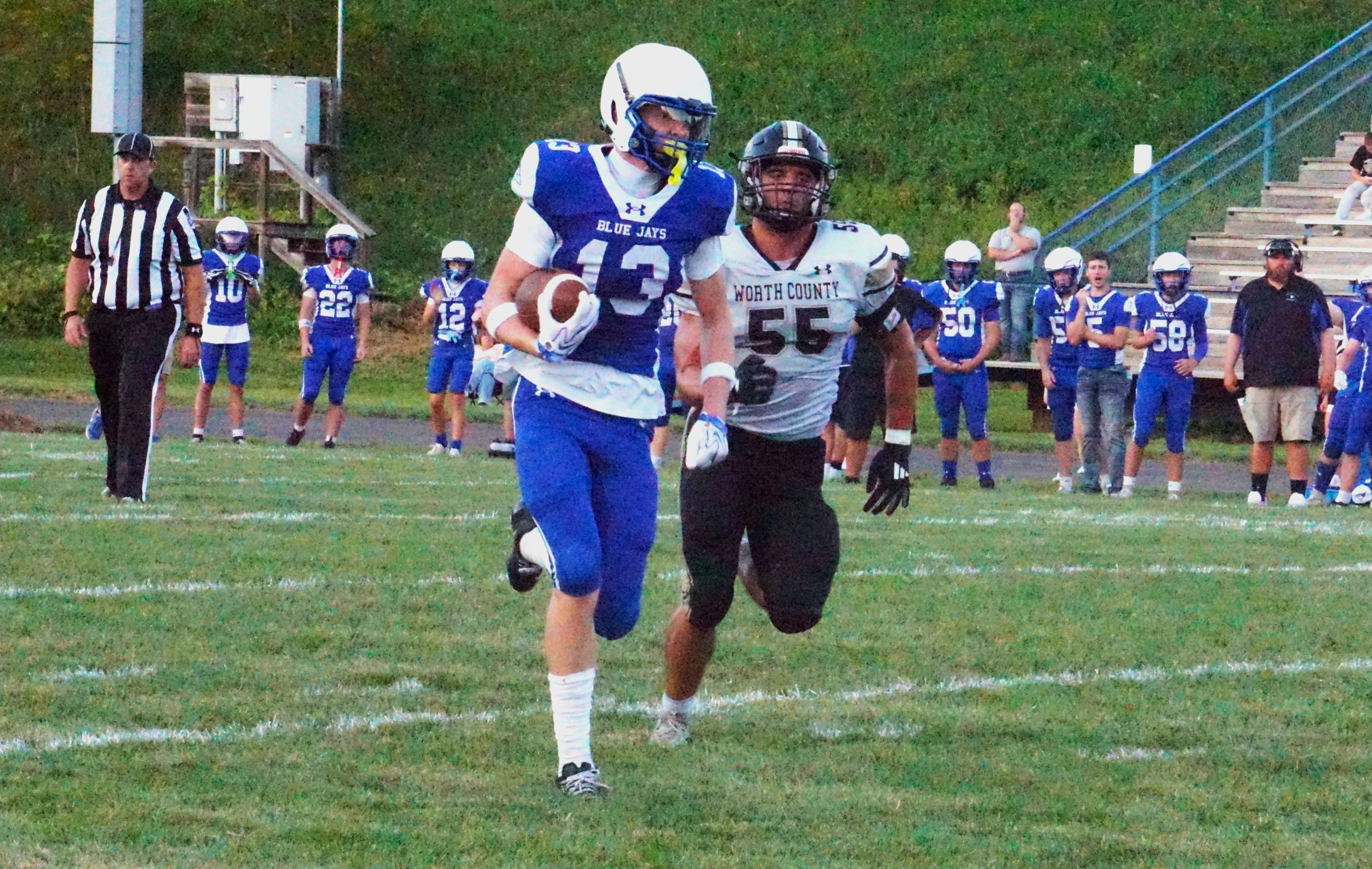 Rock Port's Reid Ellis (13) takes a catch in for a touchdown/ Photo by Matt Pike