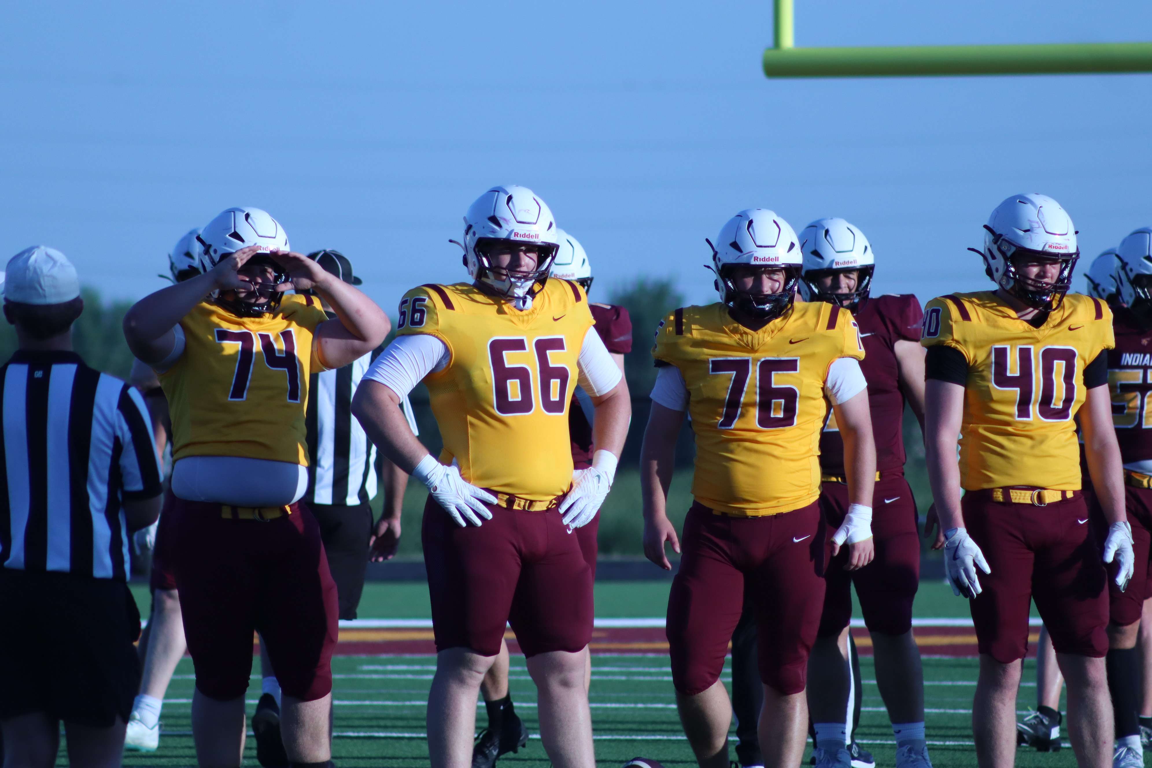 (74) Caleb Englert, (66) Gus Corsair, (76) Brady Barber and (40) Isaac Loving look for play signals from the sideline.