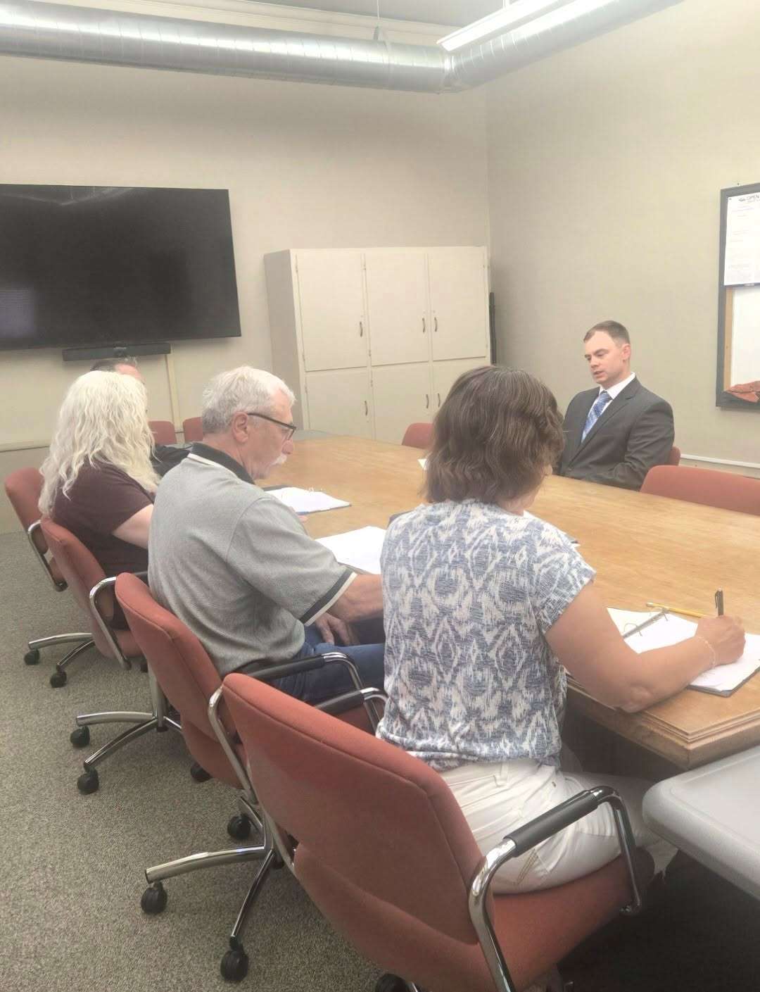 Picture of Civil Service Commissioners interviewing Officer Hart.