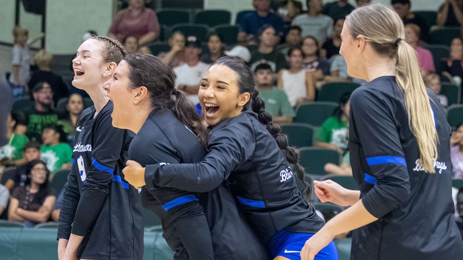 Blue Dragon players celebrate a point in the fourth set of a come-from-behind 3-1 KJCCC victory on Monday night at Seward County.