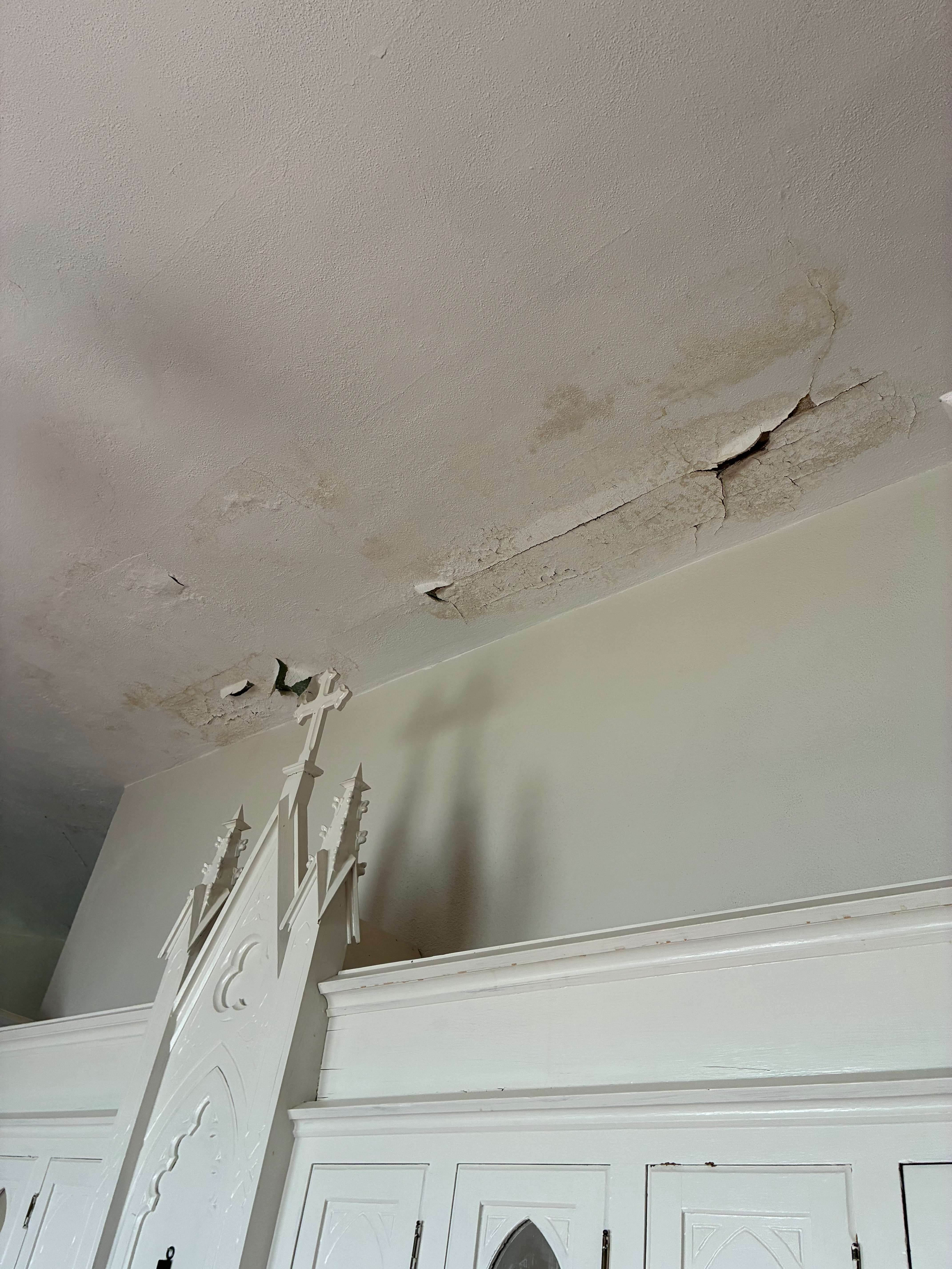 Water damage accumulated over the years is visible from the church basement, showing deterioration to the floor above. Photo by Alin Hett/Hays Post