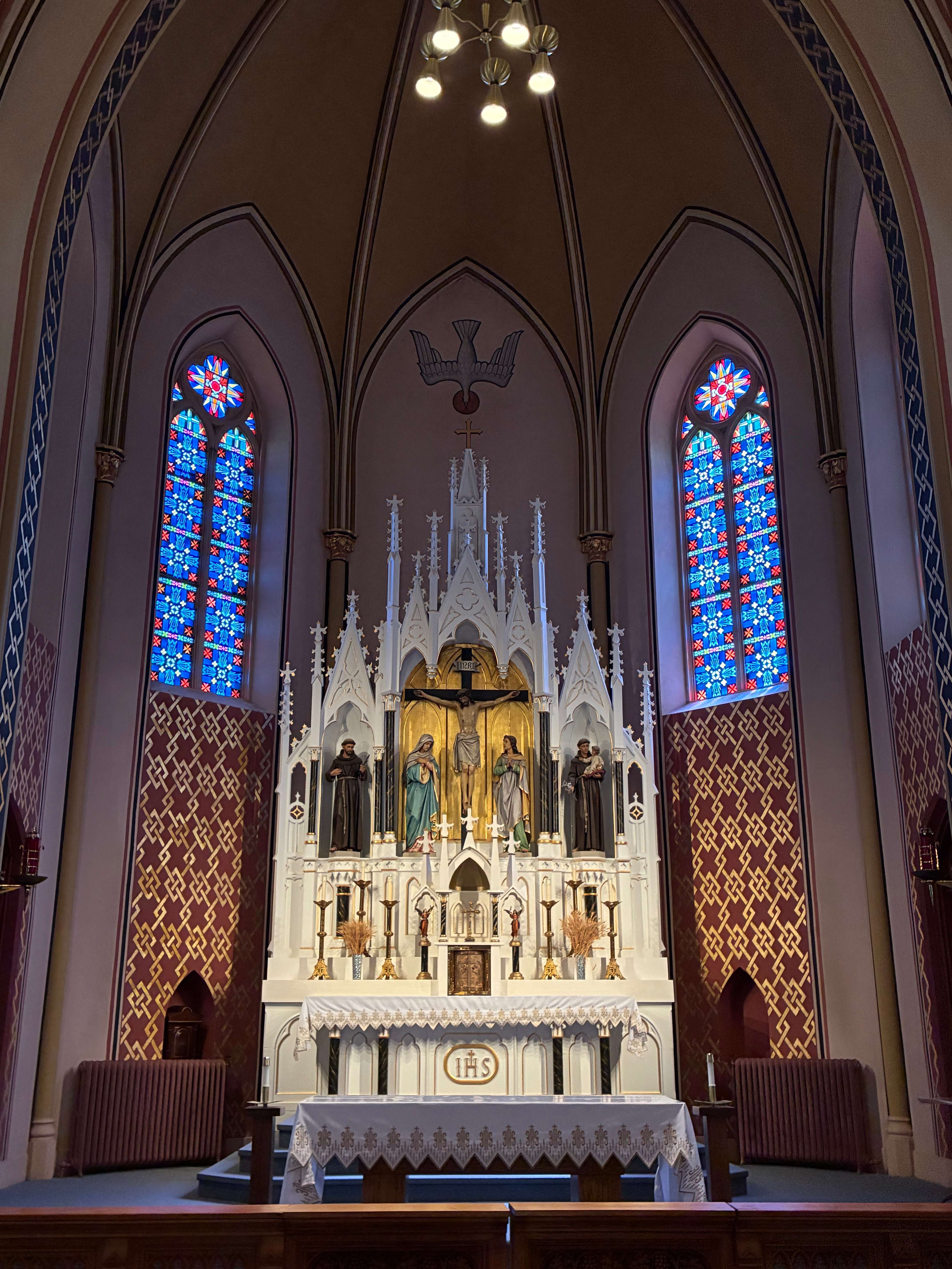 Four stained-glass windows behind the altar will be the focus of the first phase of restoration that cost about $84,000, as they are among those most in need of repair. Photo by Alin Hett/Hays Post.&nbsp;
