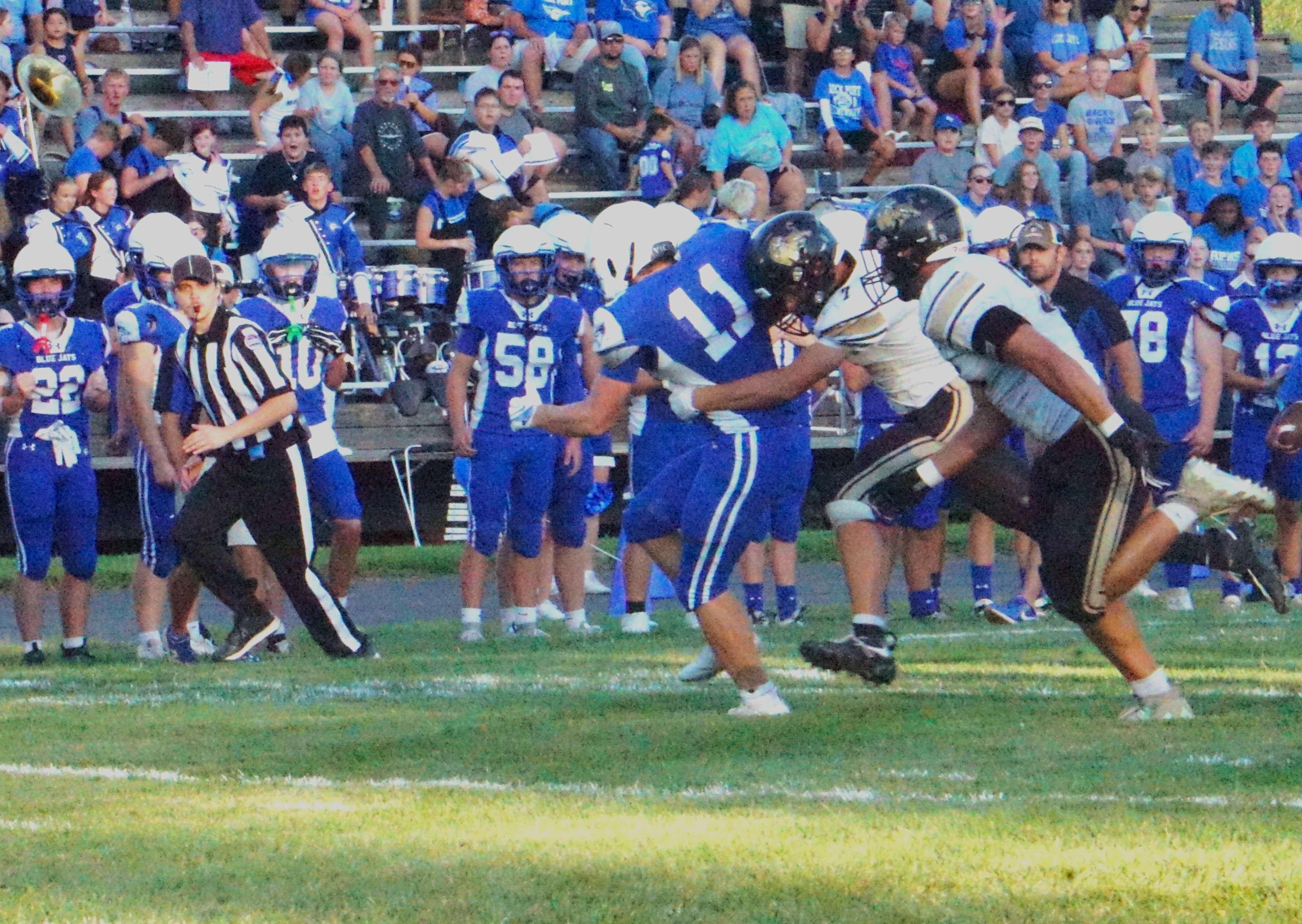 Rock Port's Brock Holmes (11) is dragged down by Worth County's Caleb New/ Photo by Matt Pike