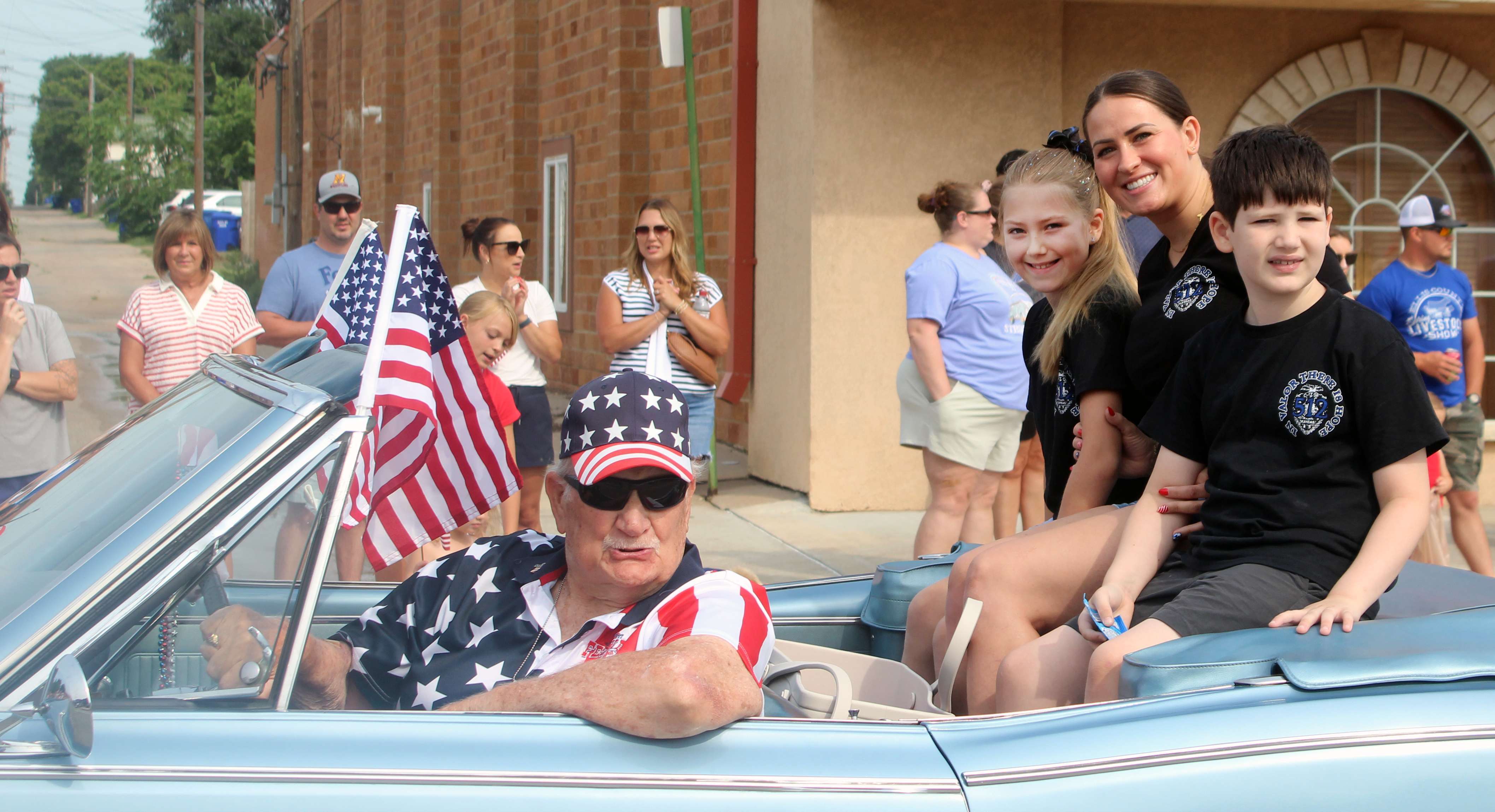 One of the founding Wild West Festival Committee members, Bob Swift, drives the Sgt. Scott Heimann family in this year's Wild West Festival parade. Heimann was killed in the line of duty in 2025. He was posthumously named the grand marshal for the parade. Swift is a past grand marshal. Photo by Cristina Janney/Hays Post