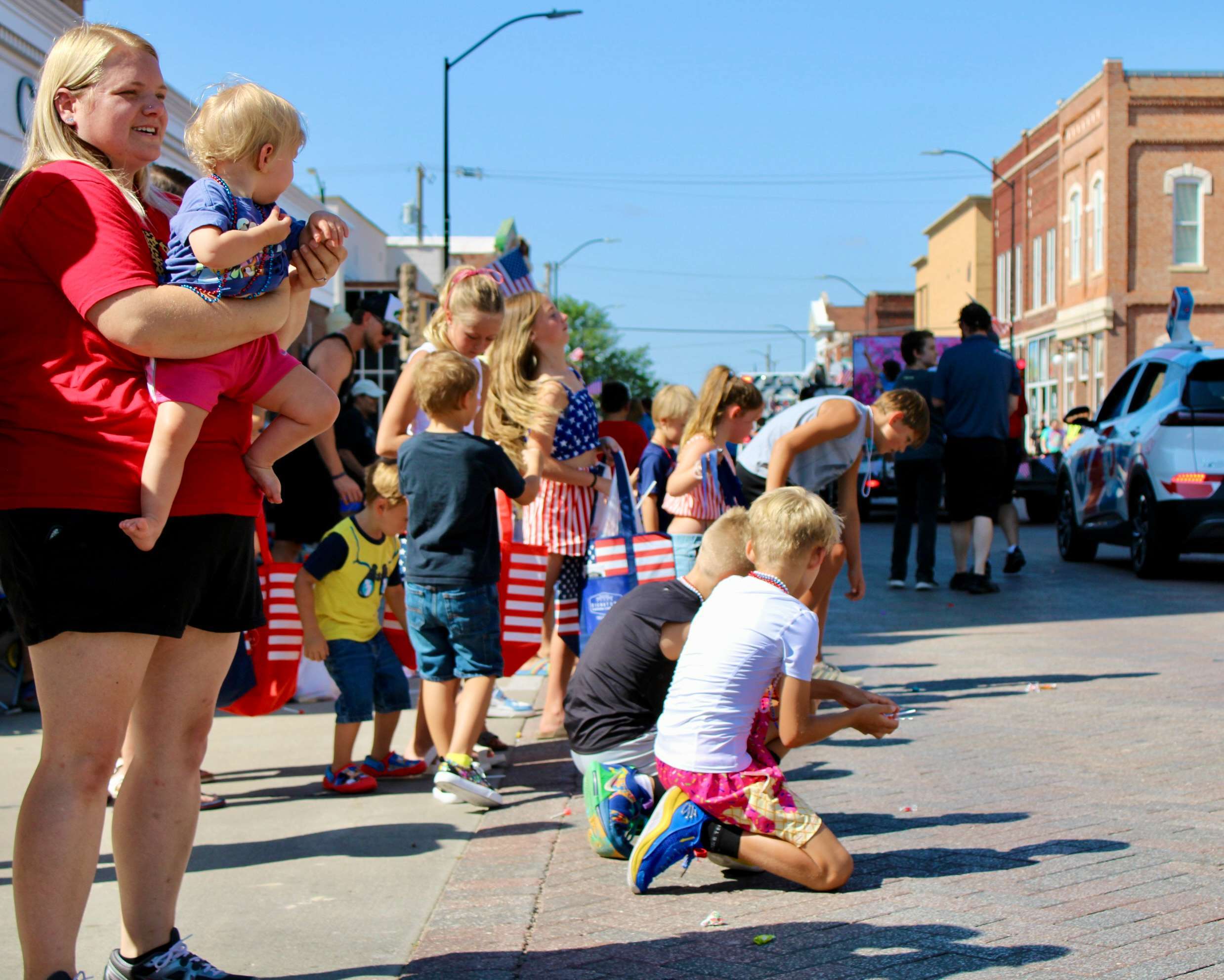 Kids scramble for candy at a Wild West Festival parade. Hays Post file photo